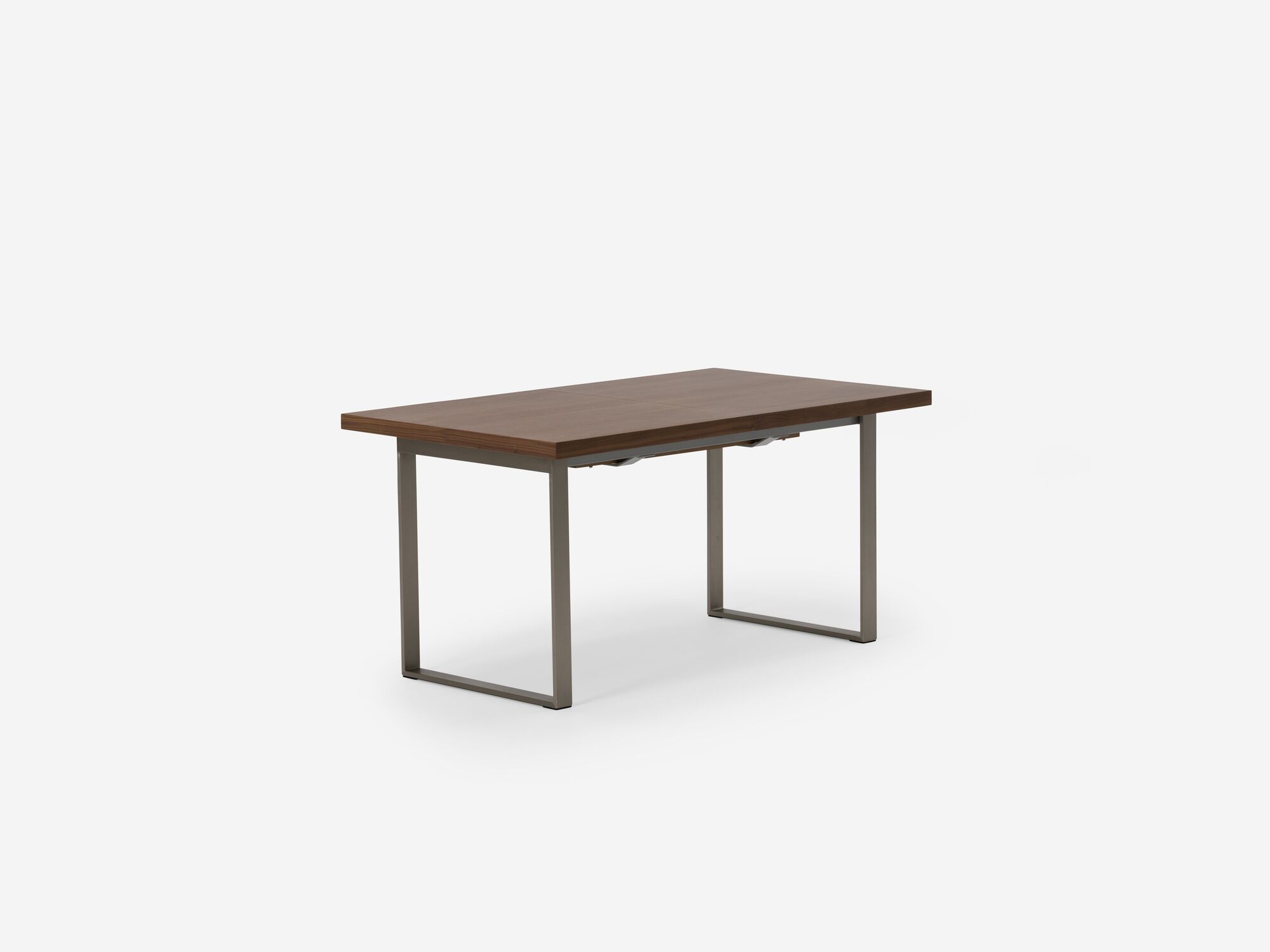 Expandable dining table with stainless steel legs and walnut top corner view