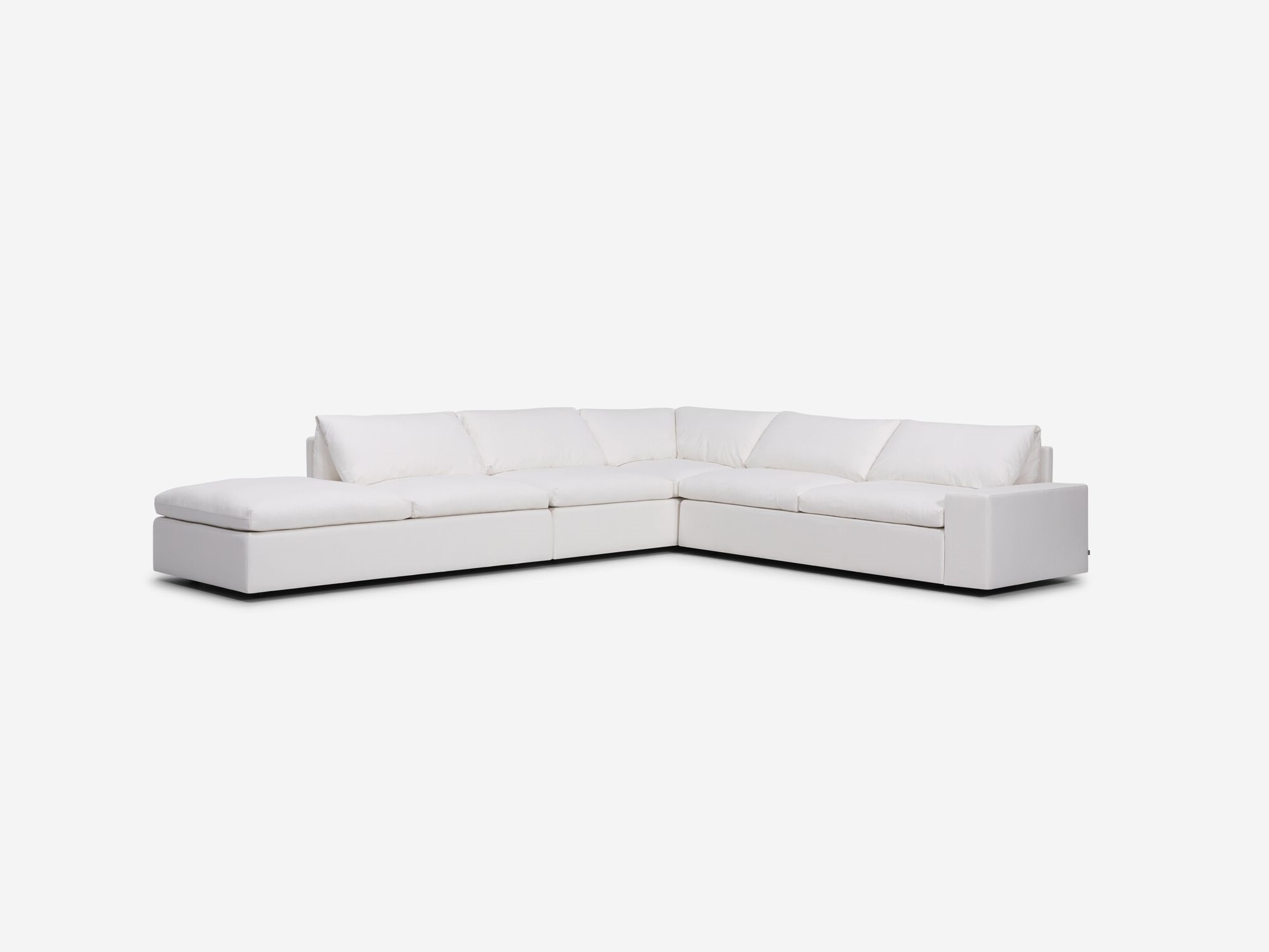 Left angle view of white sectional sofa with left hand chaise and wide arms