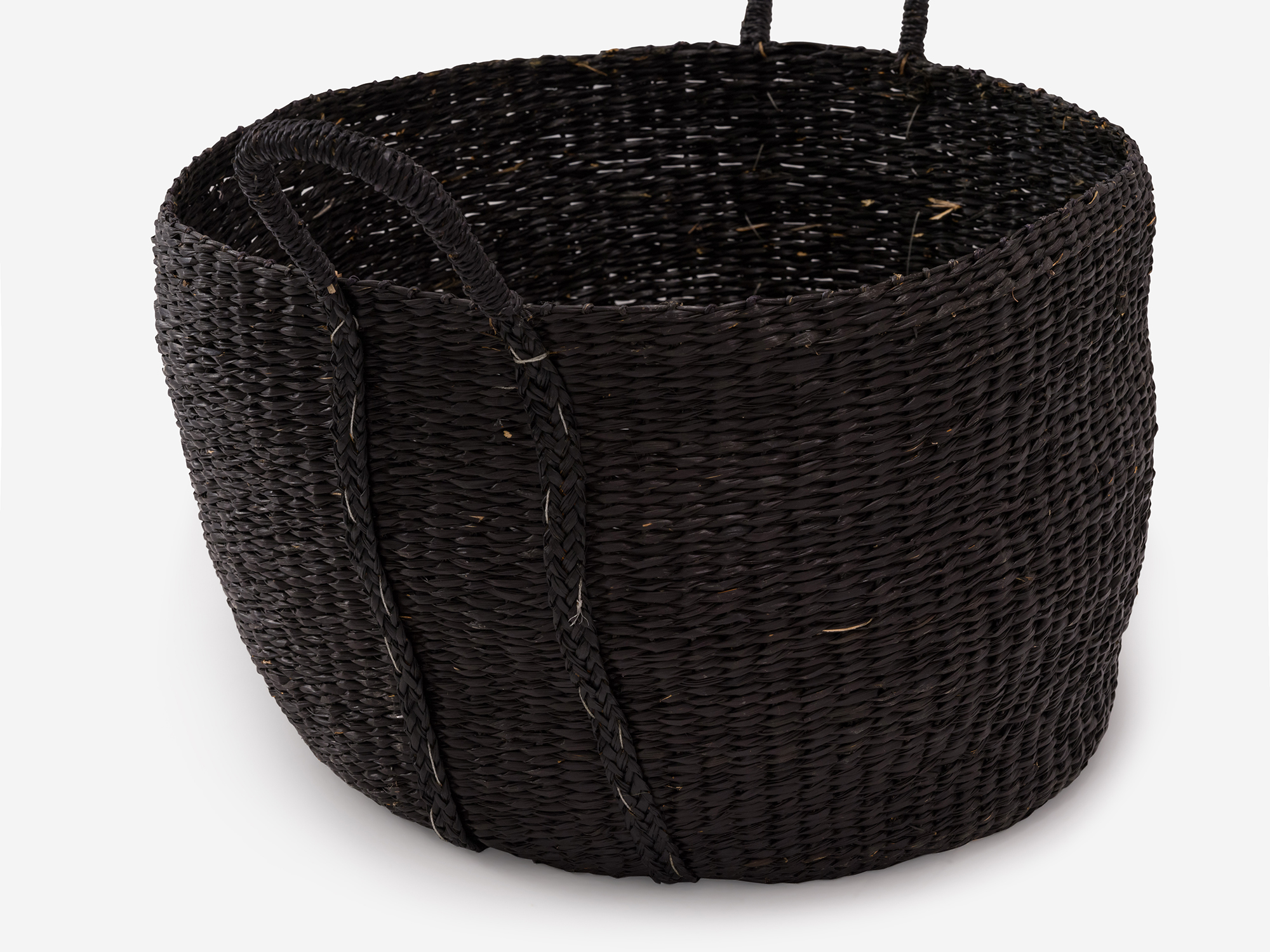 Detail view of large black woven basket with loops