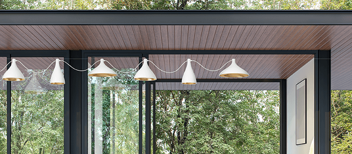 Row of white pendant lamps over outdoor patio