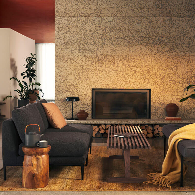 grey fabric chairs and bench are displayed in front of a modern fireplace. Link to living category