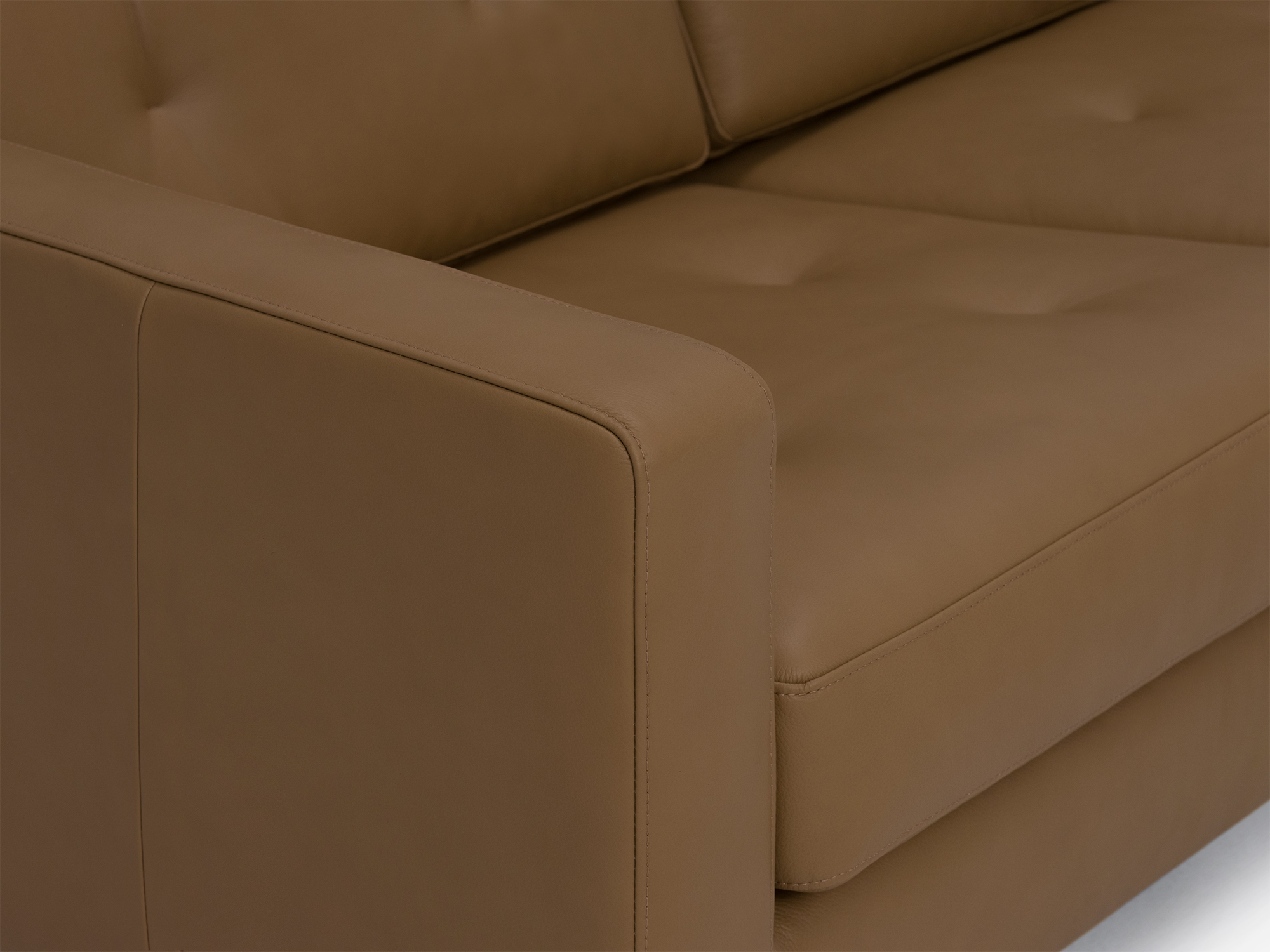 Arm detail view of the Joan loveseat in brown leather