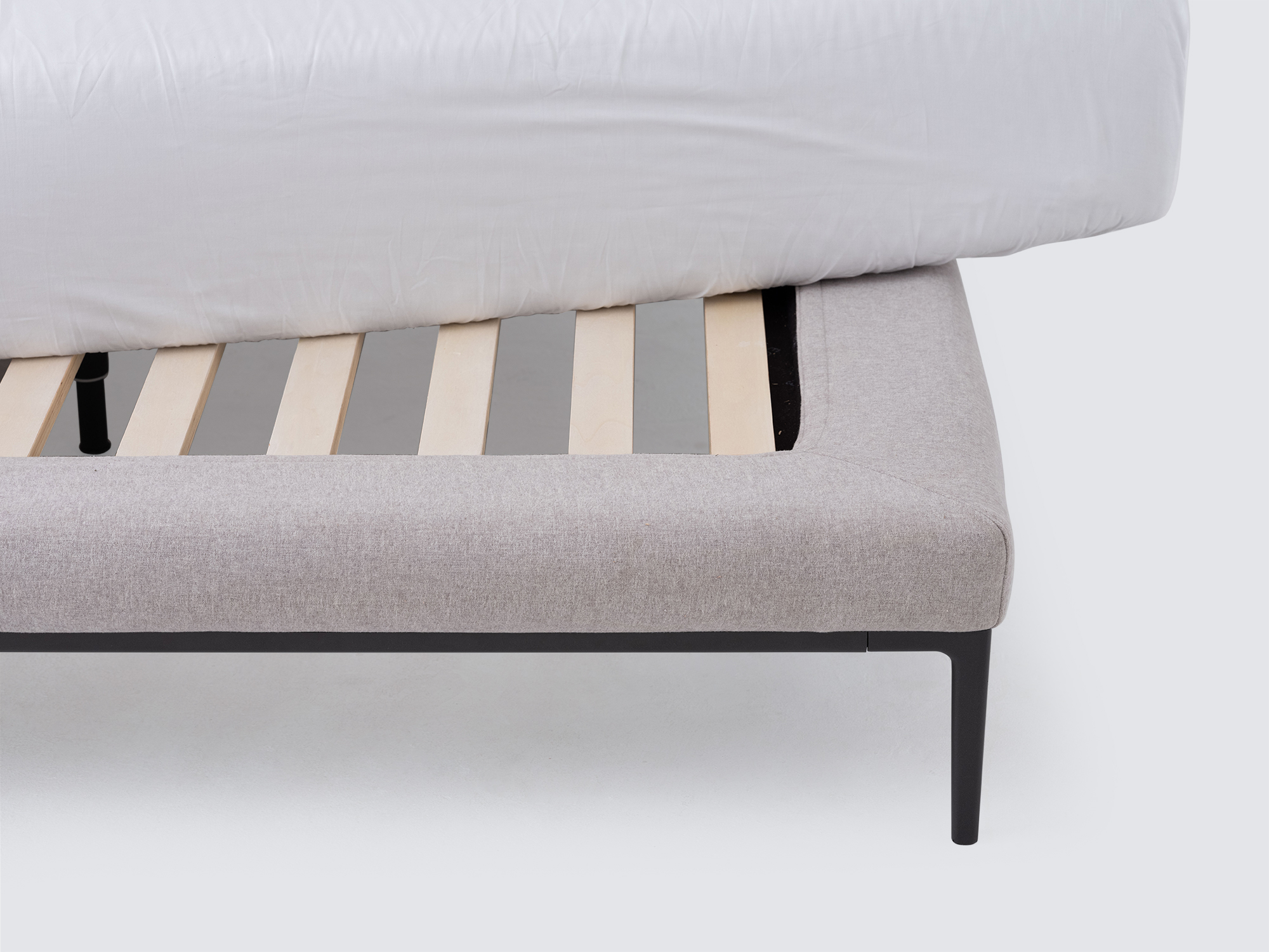 Slat detail view of the Oma modern upholstered bed in grey fabric