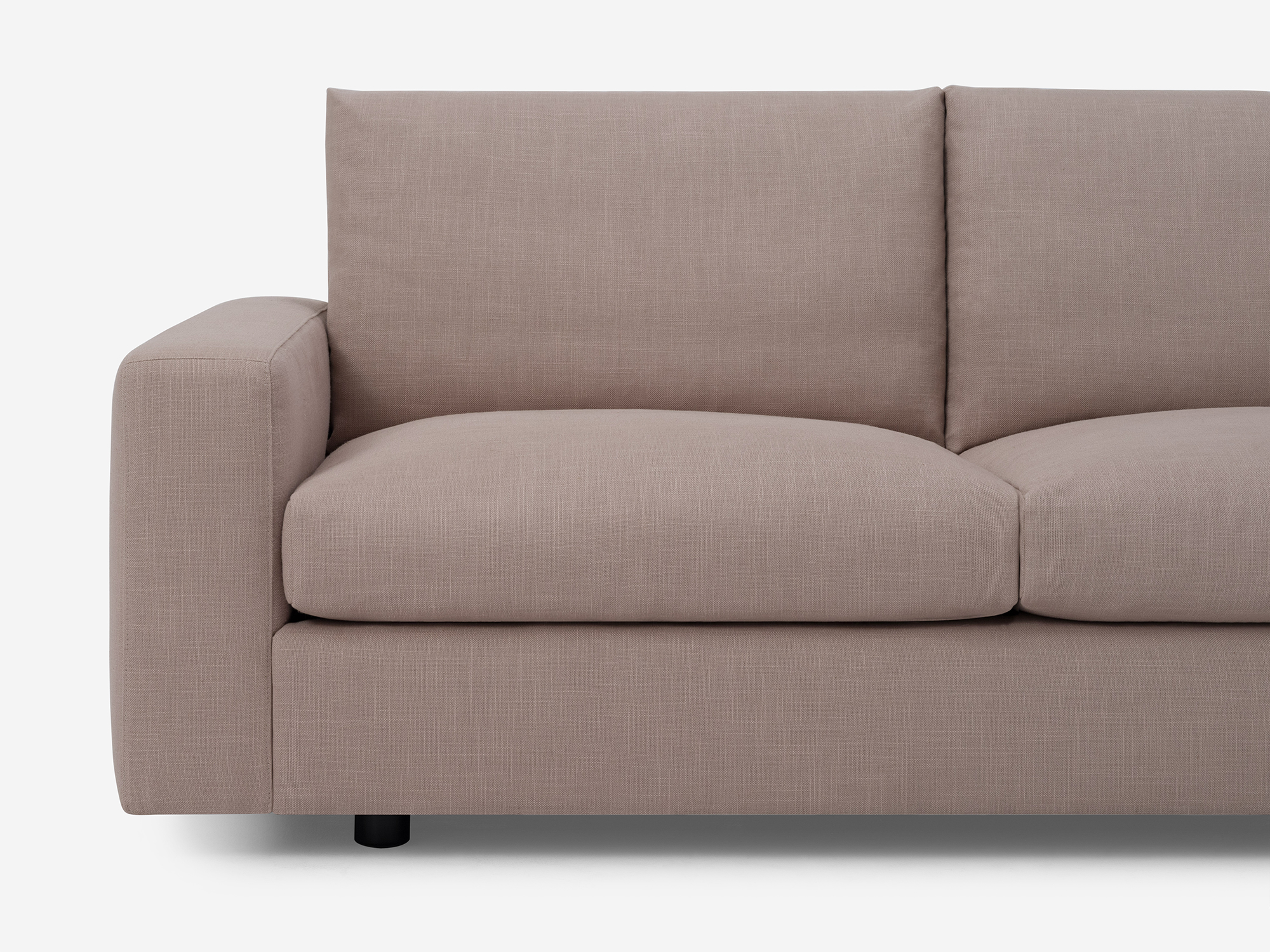 Detail front view of grey fabric loveseat with narrow arms