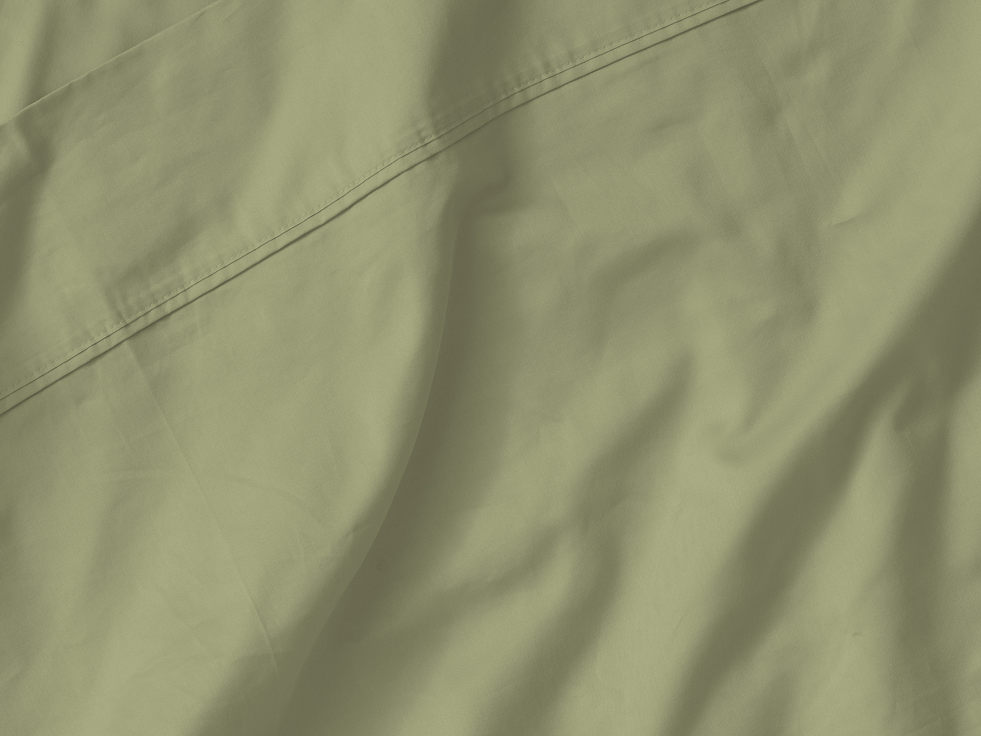 Detail view of top fold of organic cotton bed sheets in green