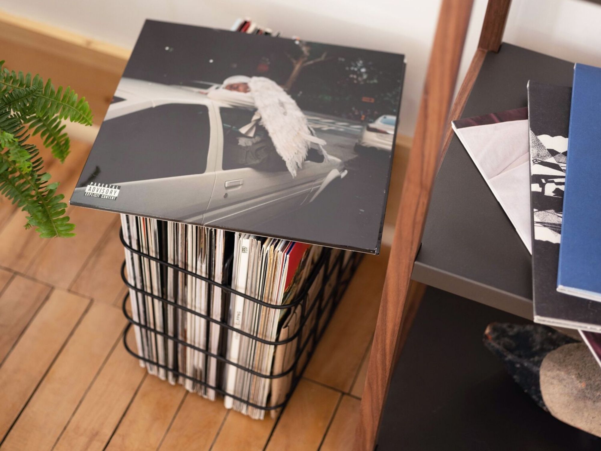 Black wire storage basket filled with vinyl records