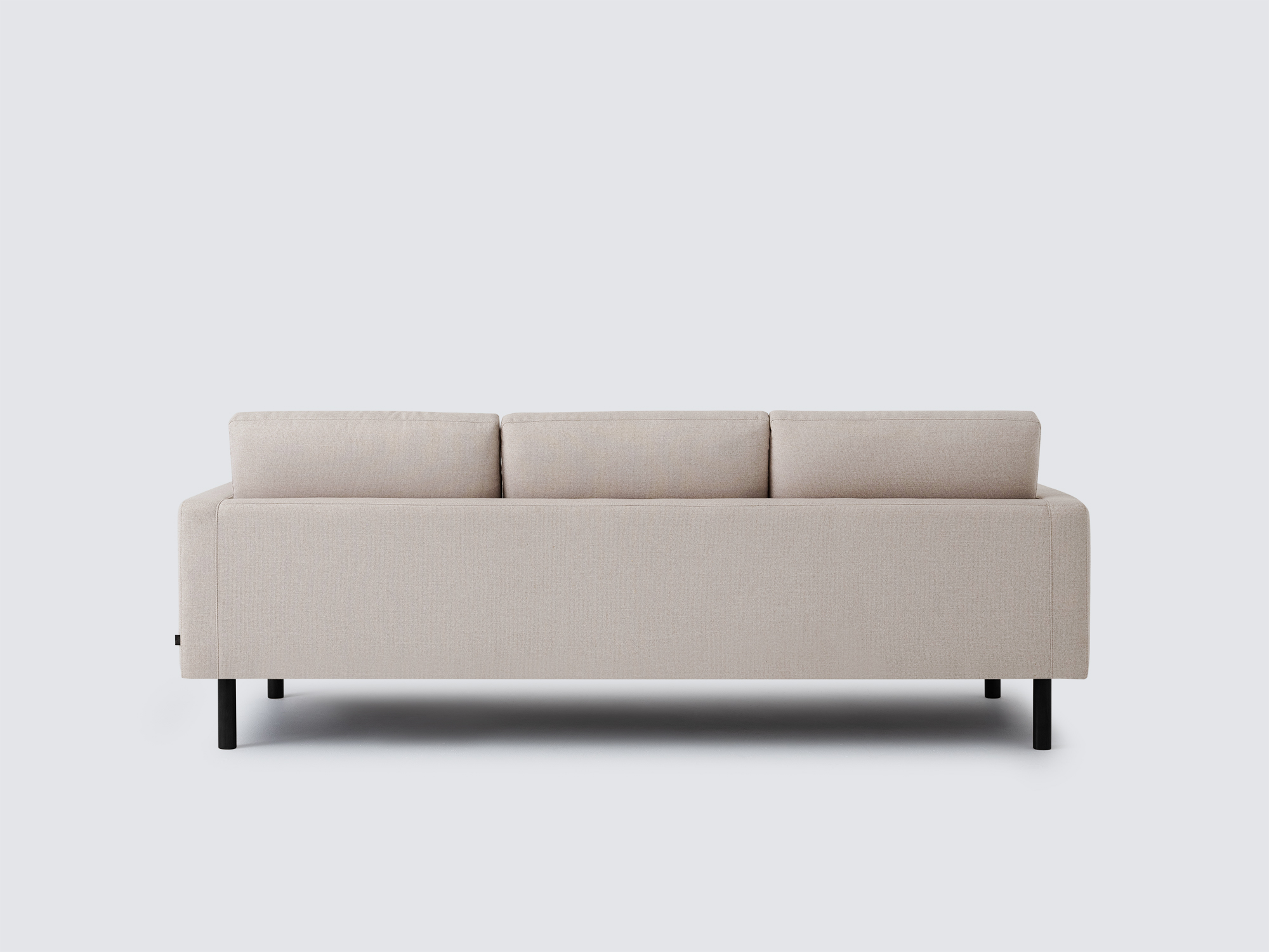 Back view of the Joan sectional upholstered in beige fabric