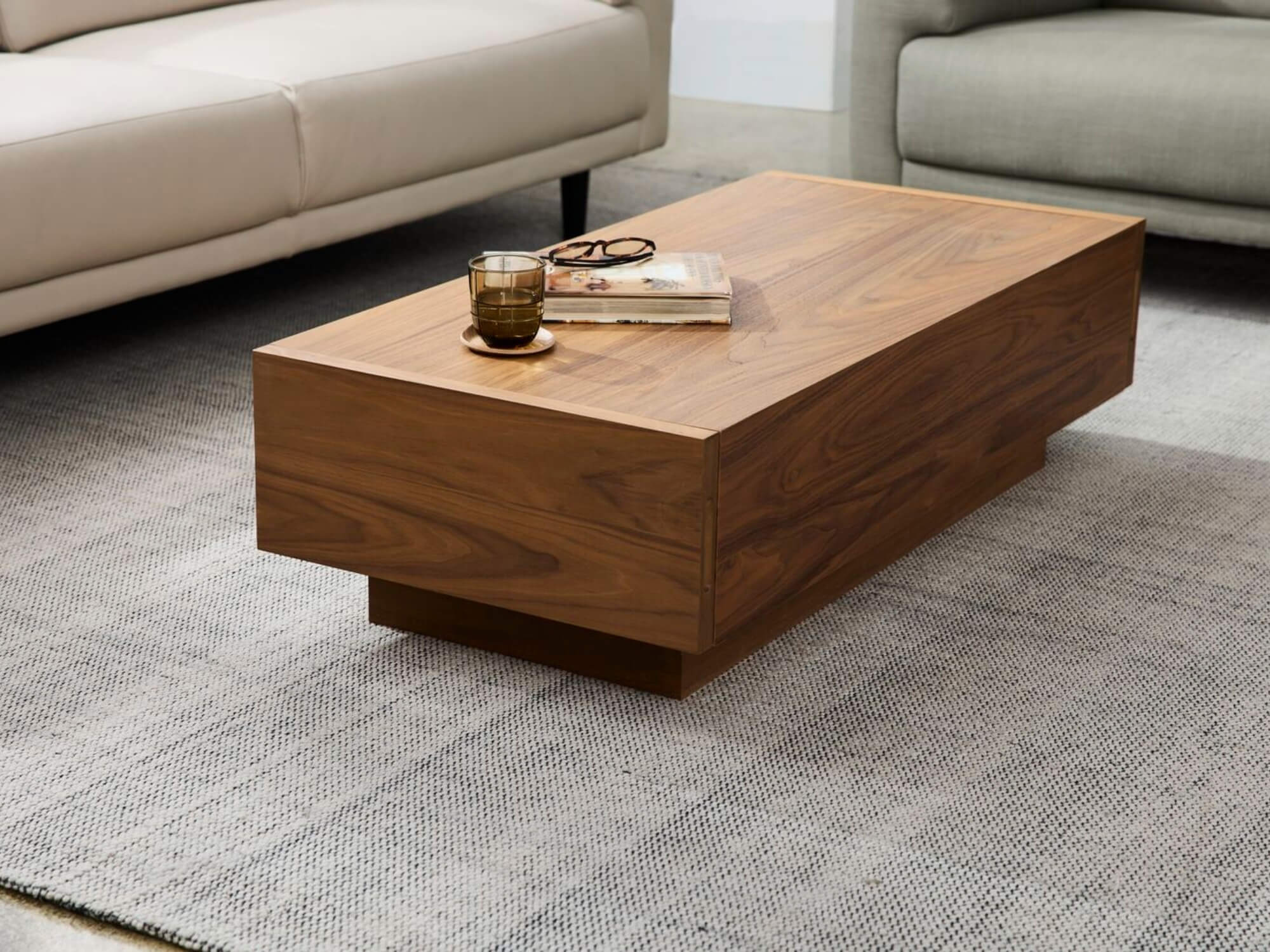 Beige rug under modern walnut coffee table