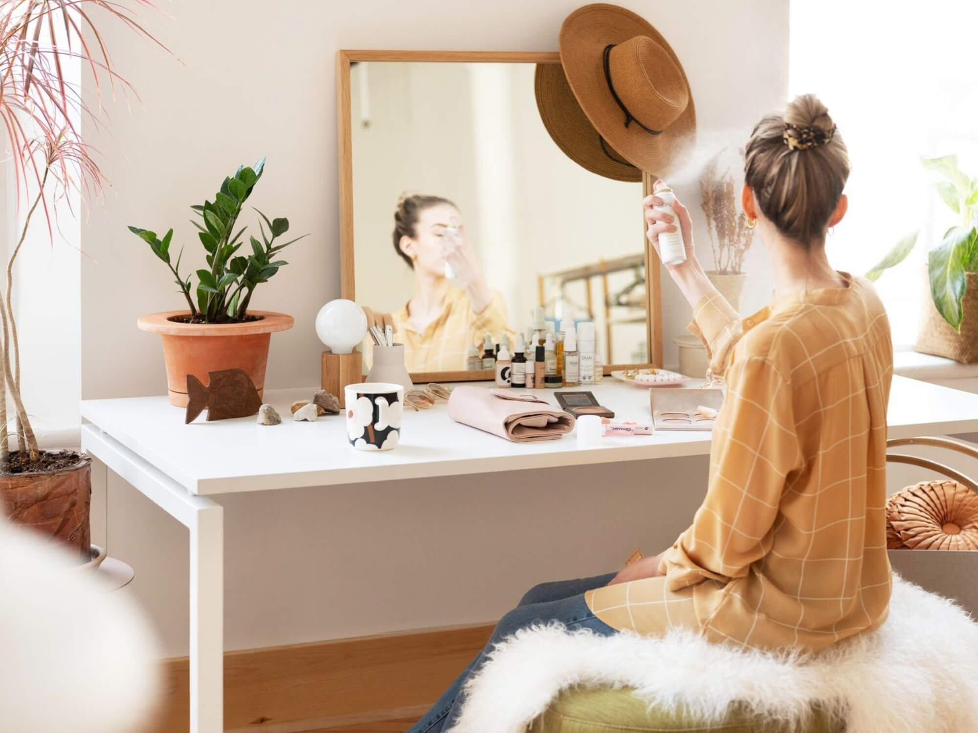 A terracotta clay plant pot on top of a bedroom vanity