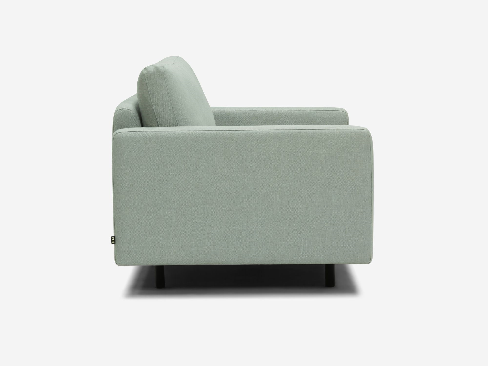 Side view of wide teal armchair