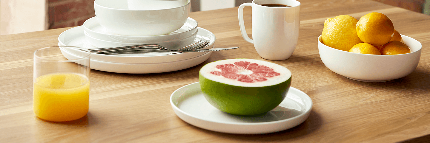 White dishware on a dining table set for breakfast