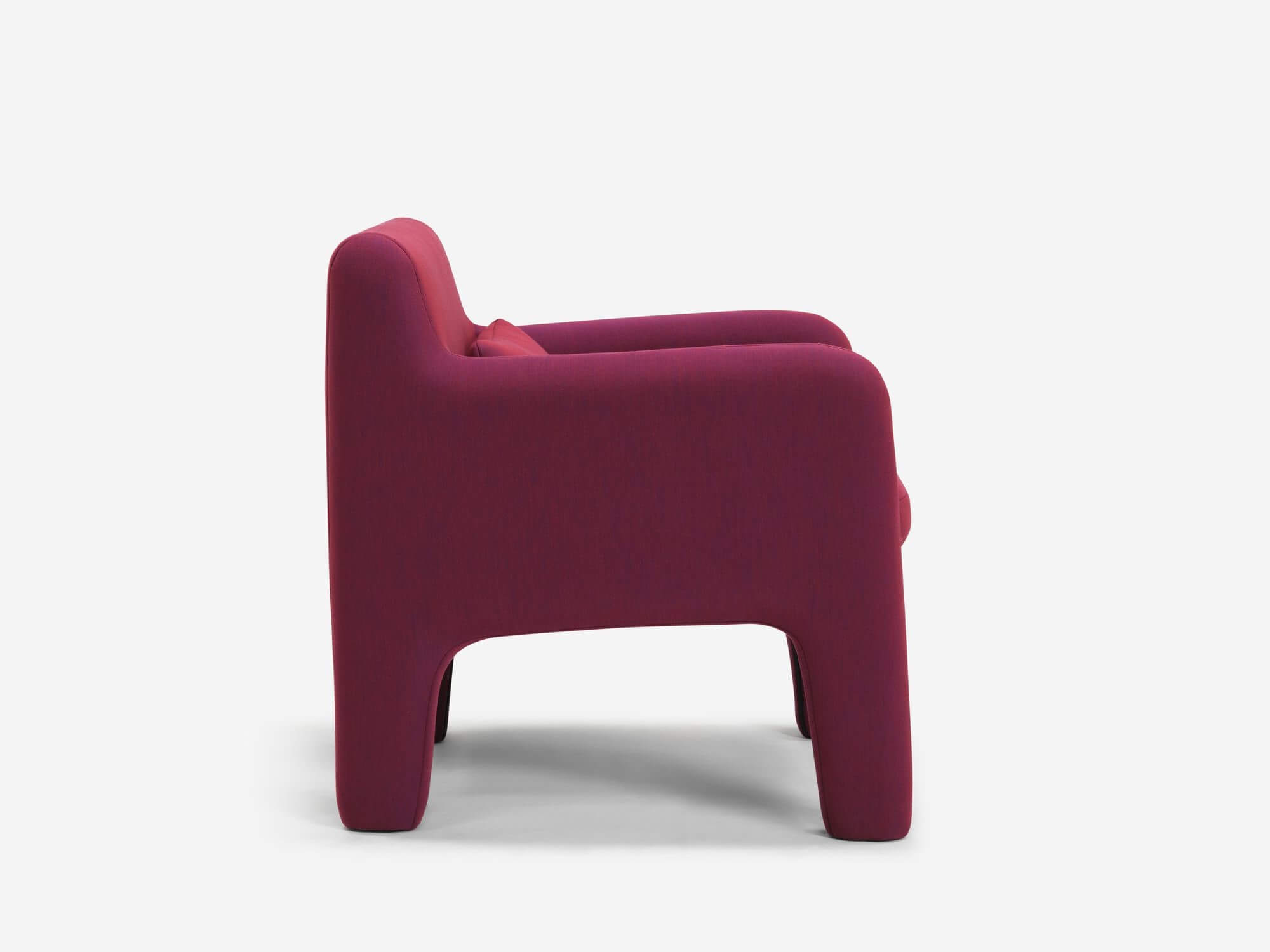 Side view of organic shaped red armchair