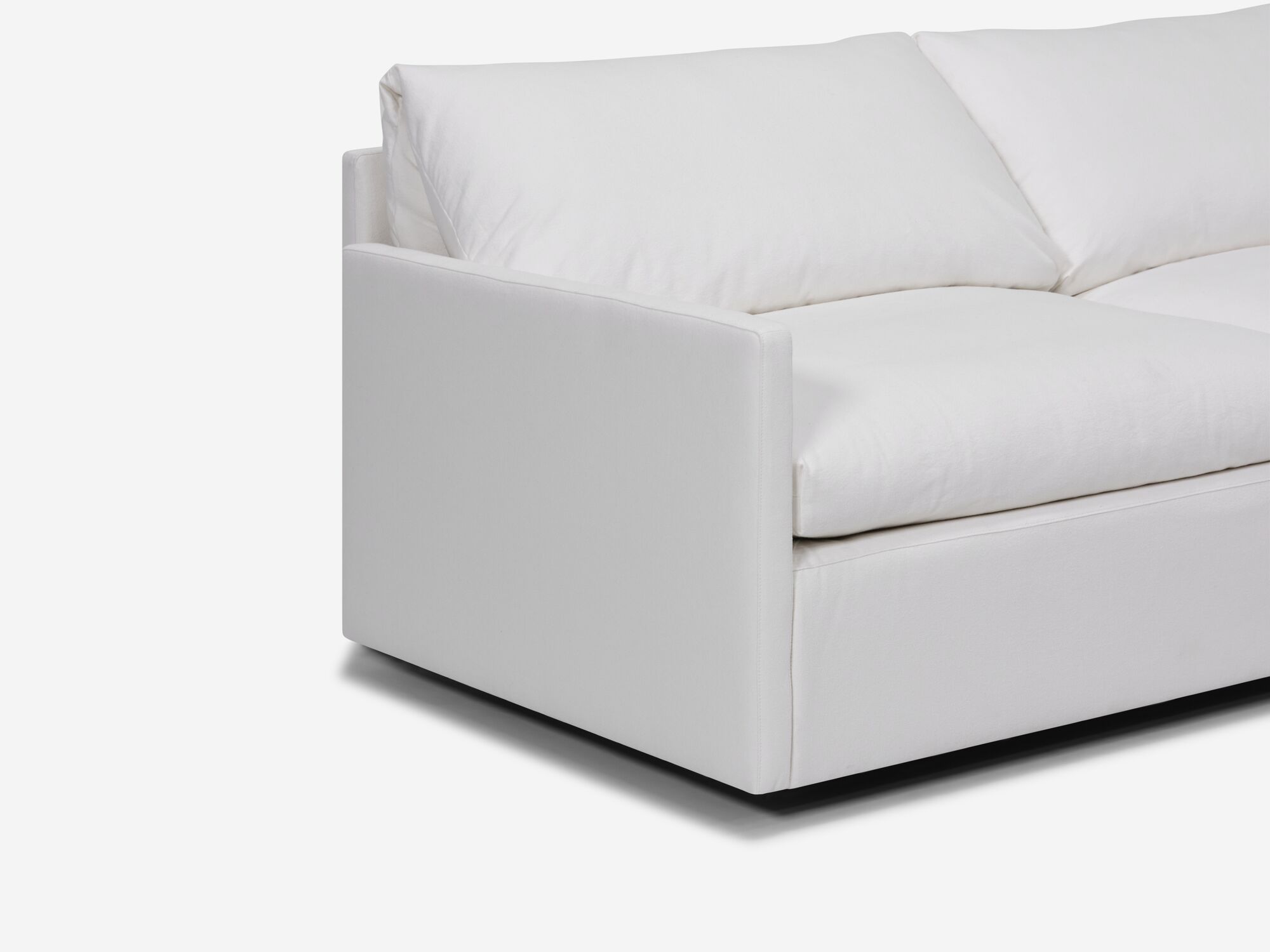 White sectional sofa with narrow arms and right hand chaise detail view