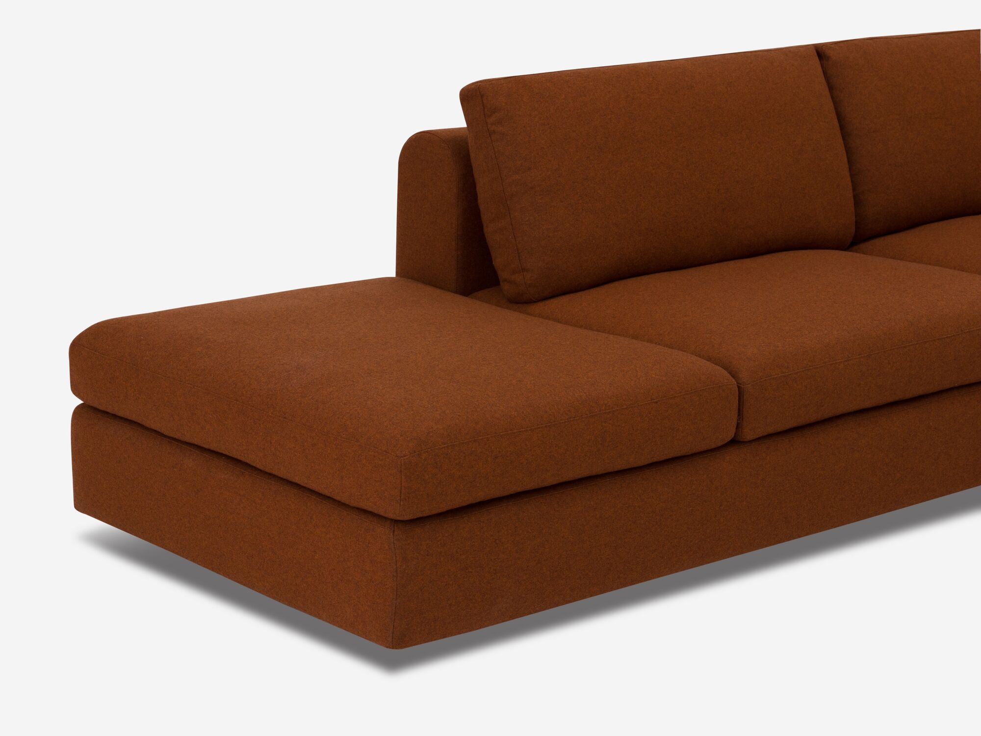 Ottoman detail view of burnt orange sectional sofa