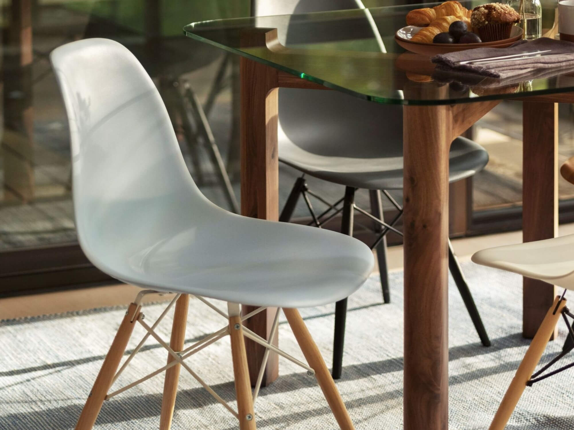 Dinette table with grey glass top and walnut base with dining chair