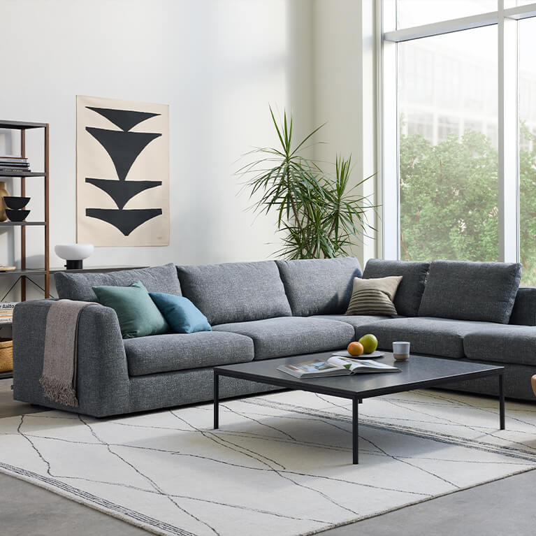 Large blue sectional sofa in a living room setting. Link to seating category