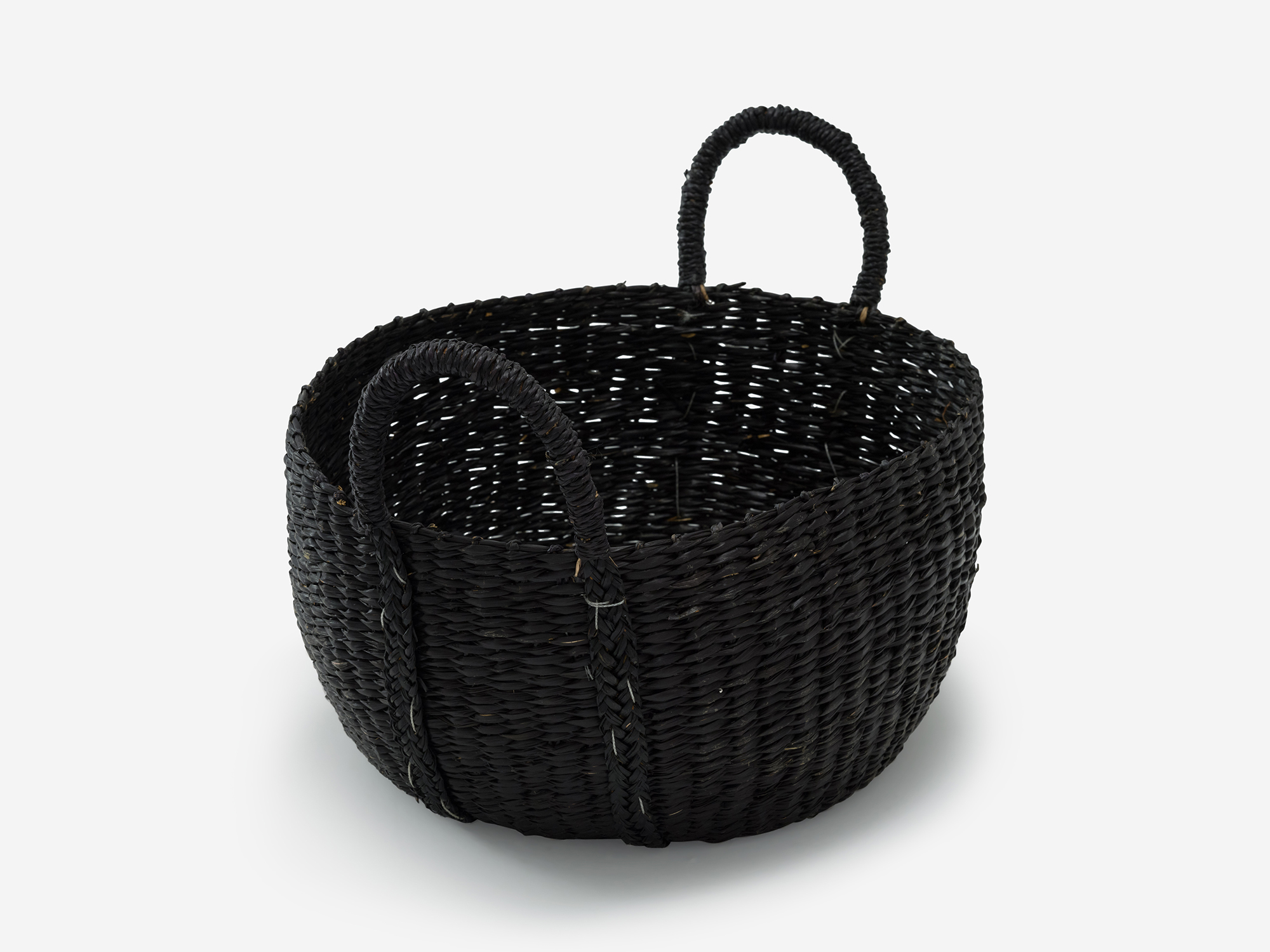 Detail view of small black woven basket with loops