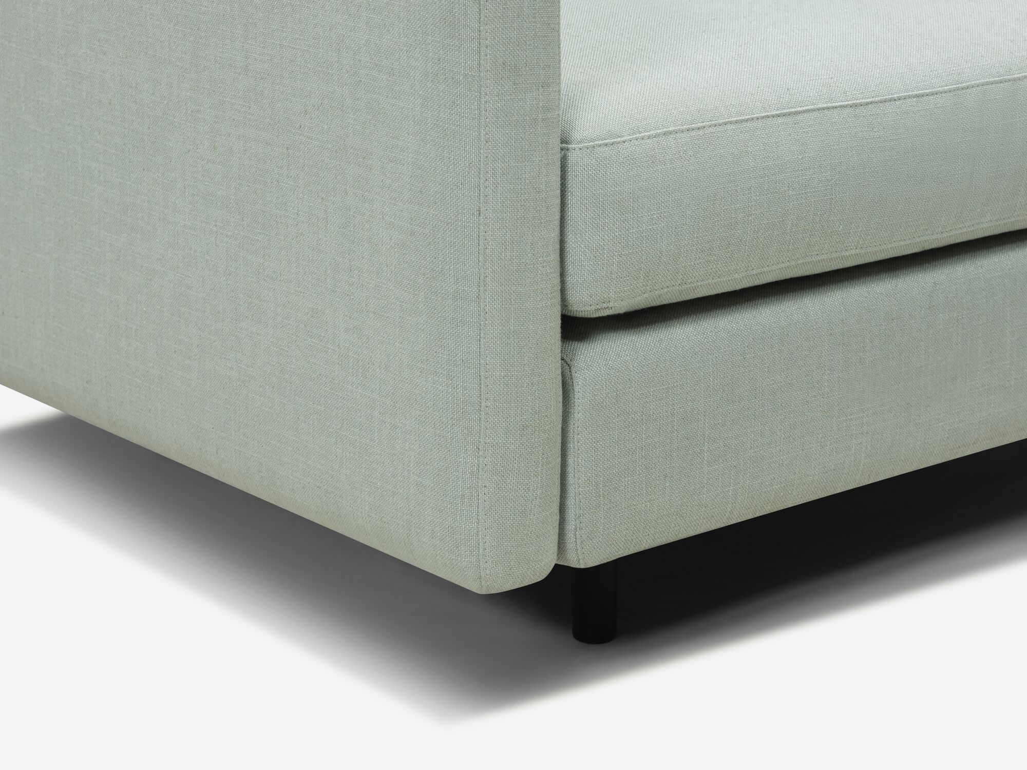 Teal armchair leg detail view