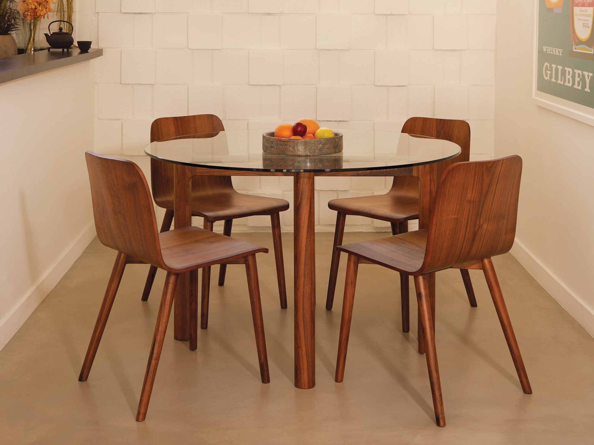 Walnut glass top dinette table and walnut chairs in a small dining space