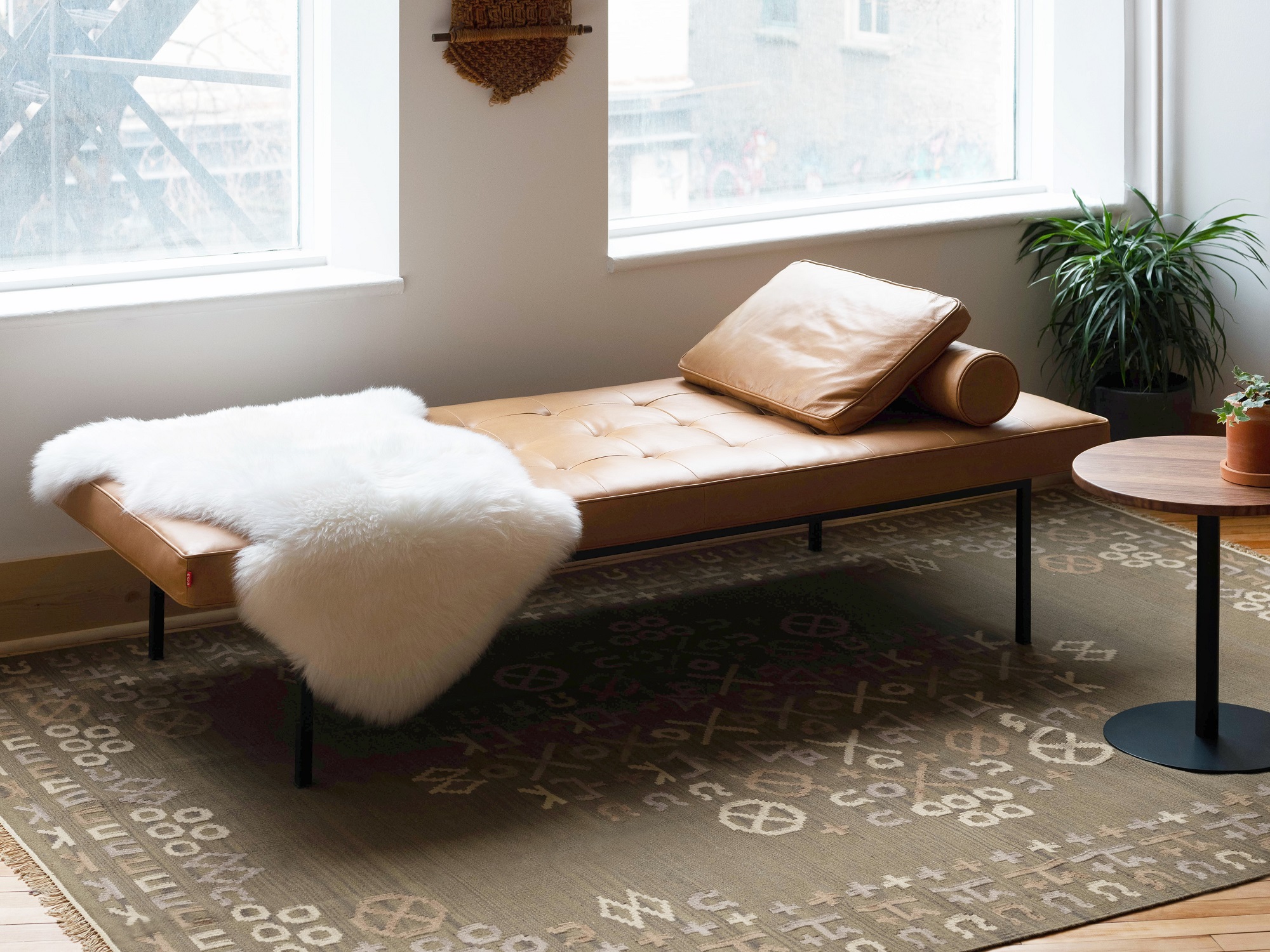 Brown leather daybed with sheepskin throw in modern living space