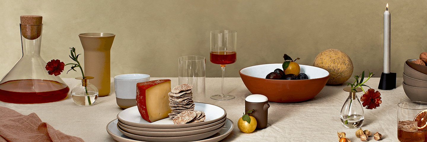 Glassware and dishware arranged on a beige tablecloth