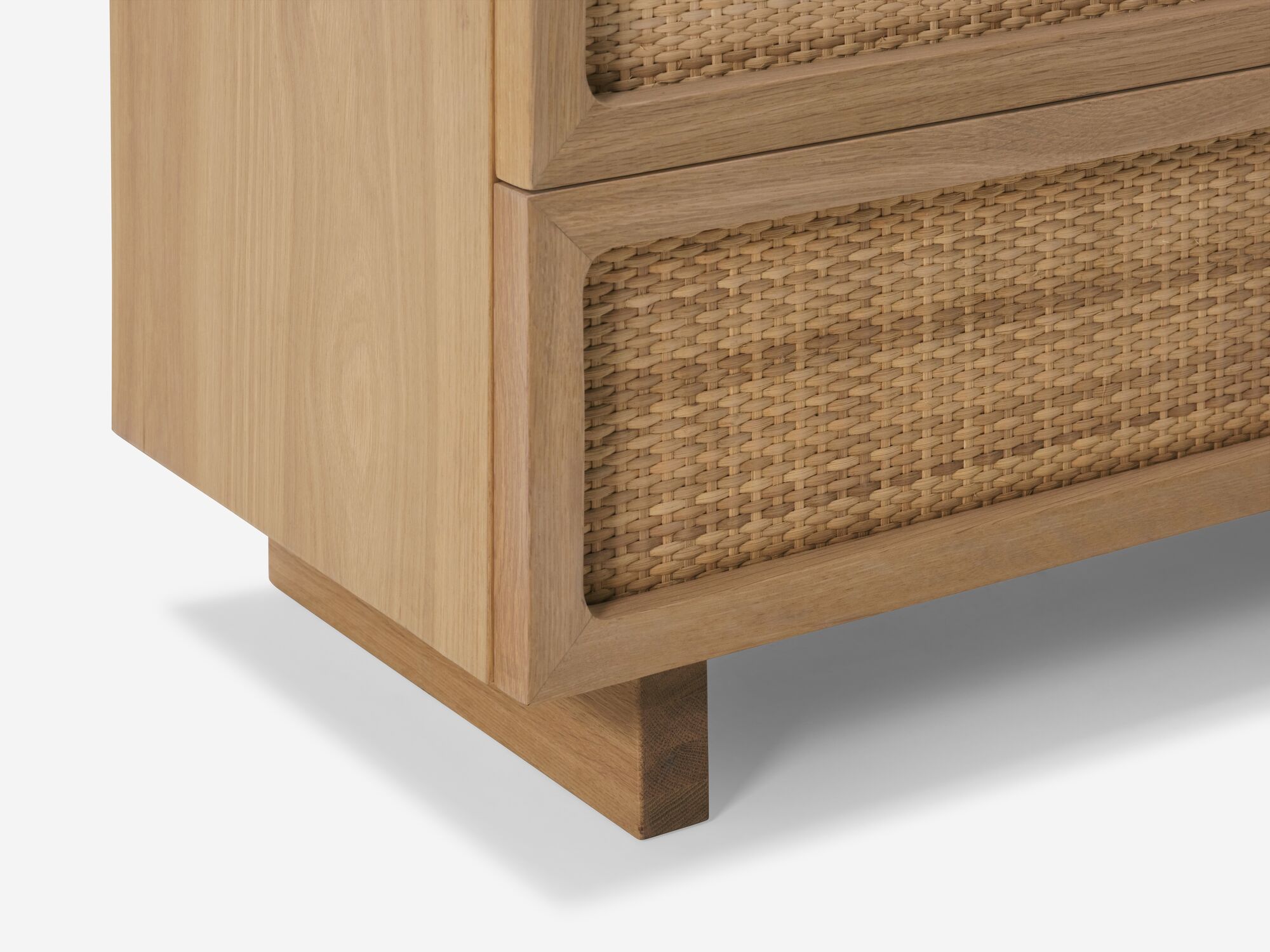 Bottom detail view of oak chest with woven drawer fronts