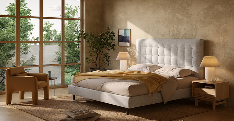 Beige queen size bed is shown in a modern bedroom space. Link to ready to ship category
