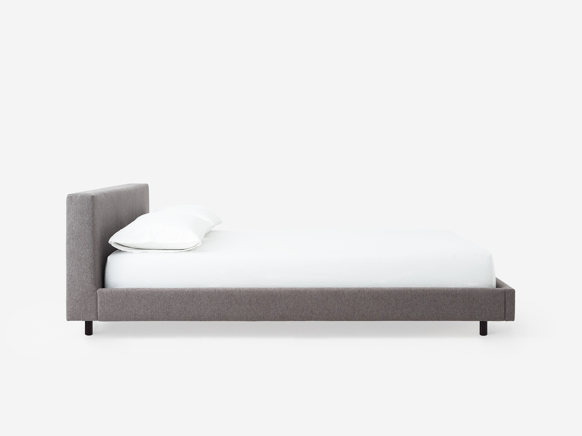 Side view of the Bento platform bed frame in grey fabric