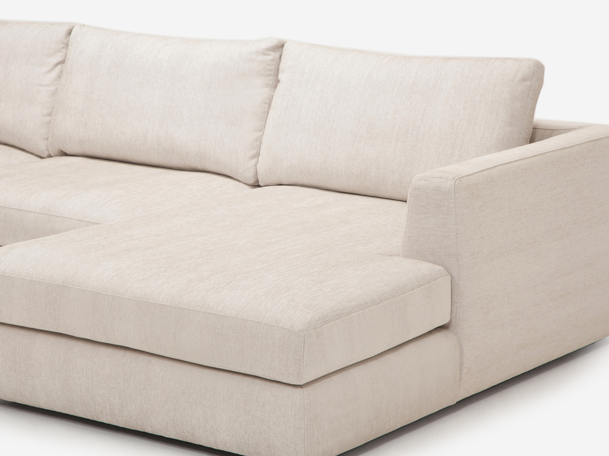 Detail chaise view of the 2 piece sectional sofa in a white fabric