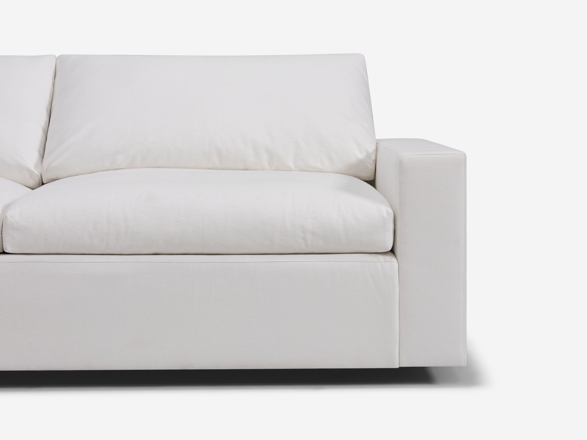 Detail view of white sectional sofa with left hand chaise