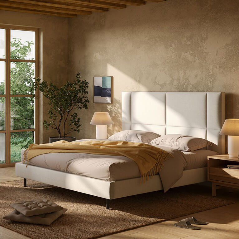 An EQ3 beige coloured fabric bed is displayed in a modern bedroom. Link to upholstered beds