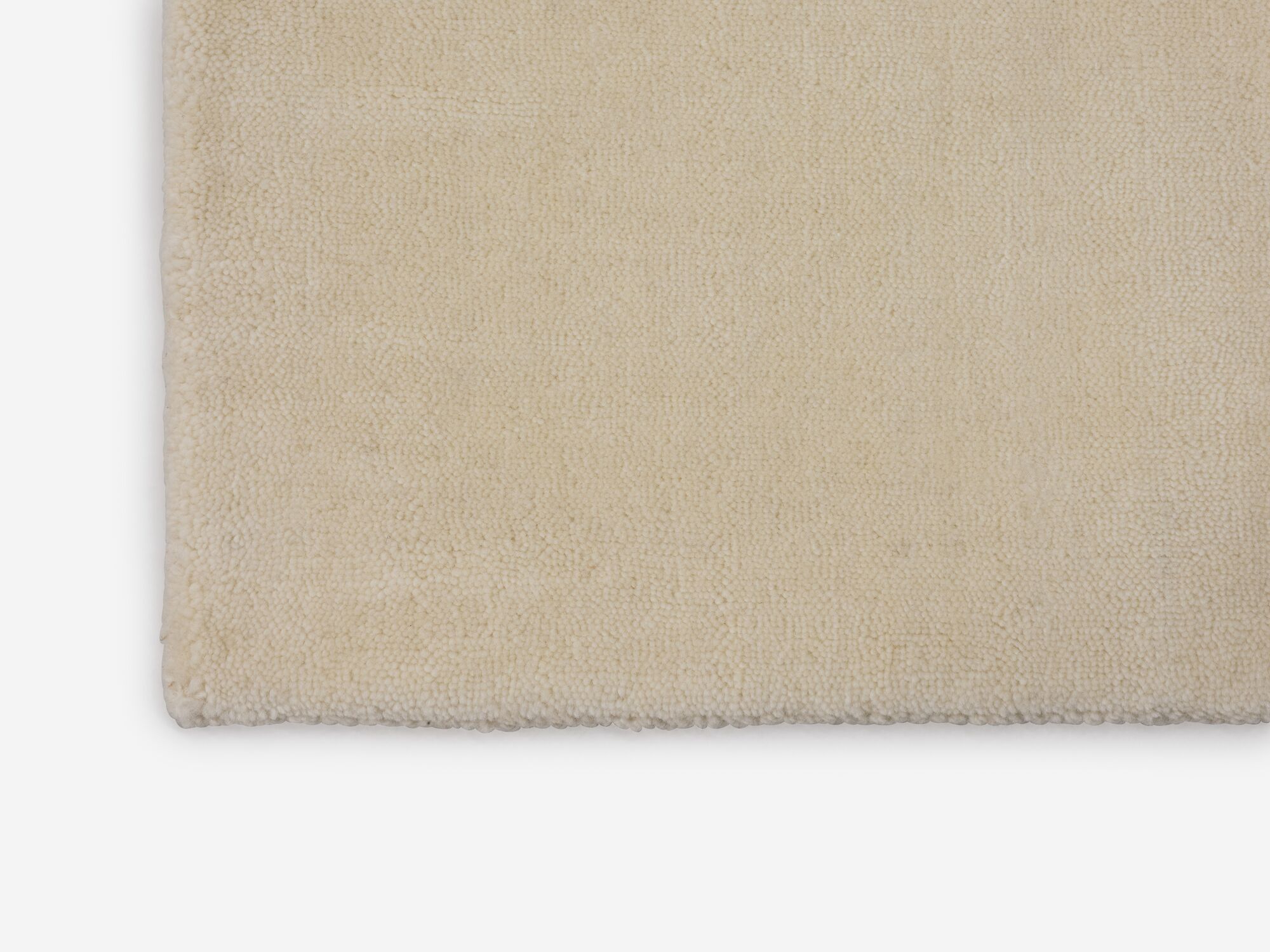 Durable cream area rug corner view