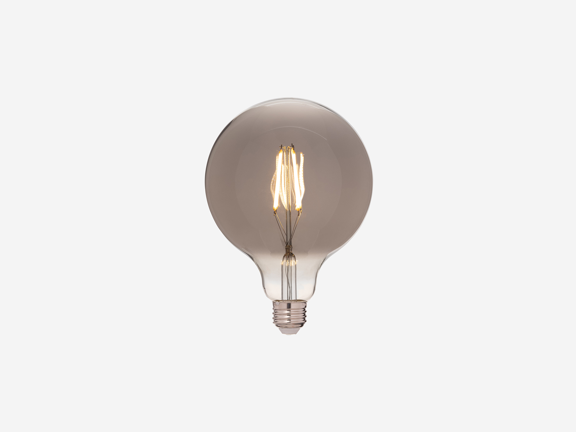 Medium round smoked grey edison light bulb with light on