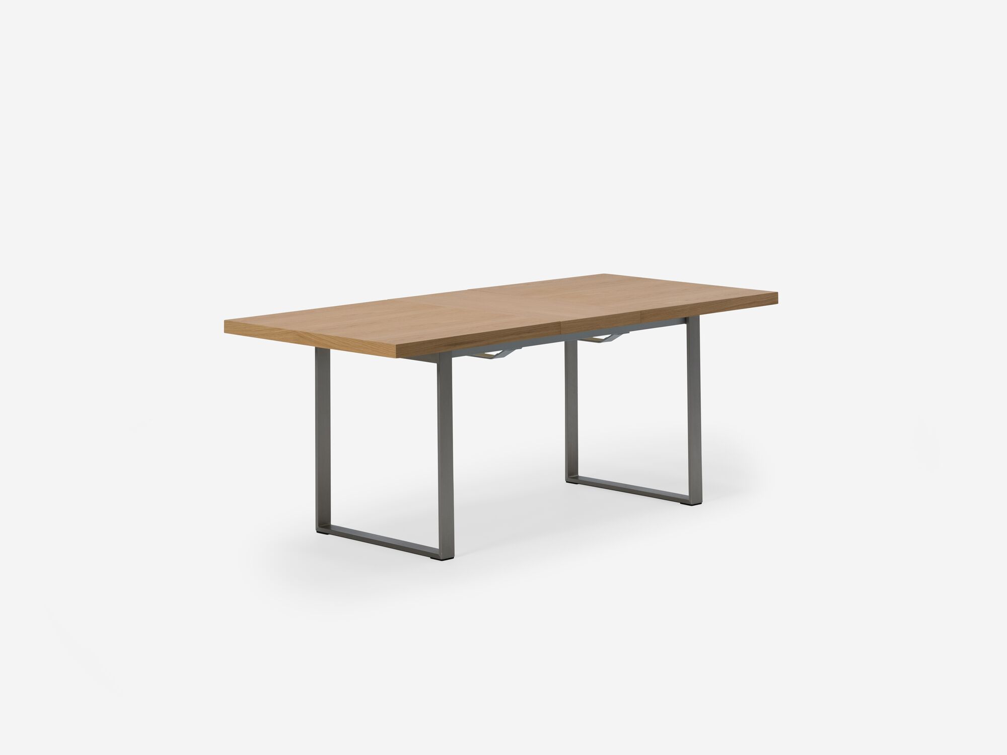 Expandable dining table with stainless steel legs, oak top and one leaf corner view