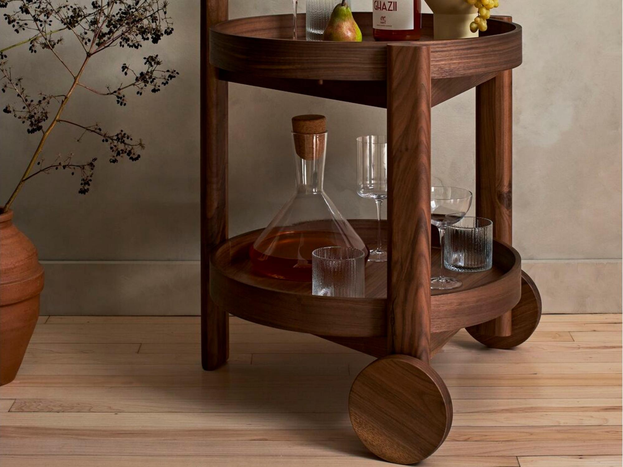 Glass wine carafe with books on a marble console table