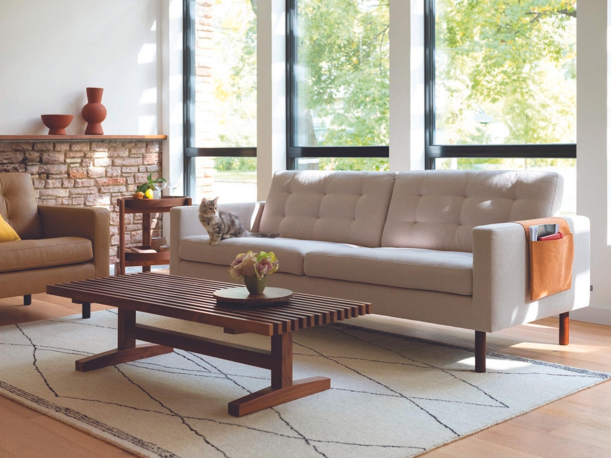 Round walnut tray on slatted walnut coffee table in mid century living space