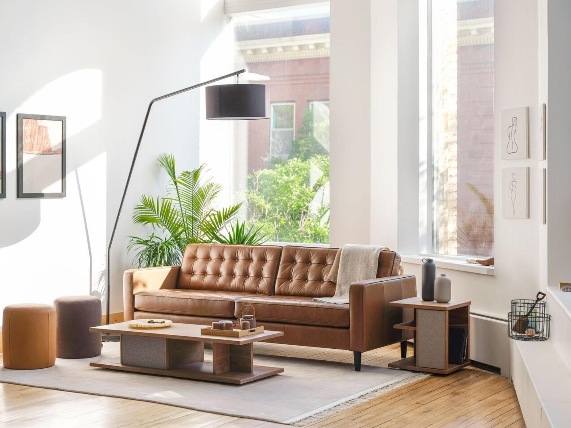 Beige throw blanket over sofa area rug in large mid century living room