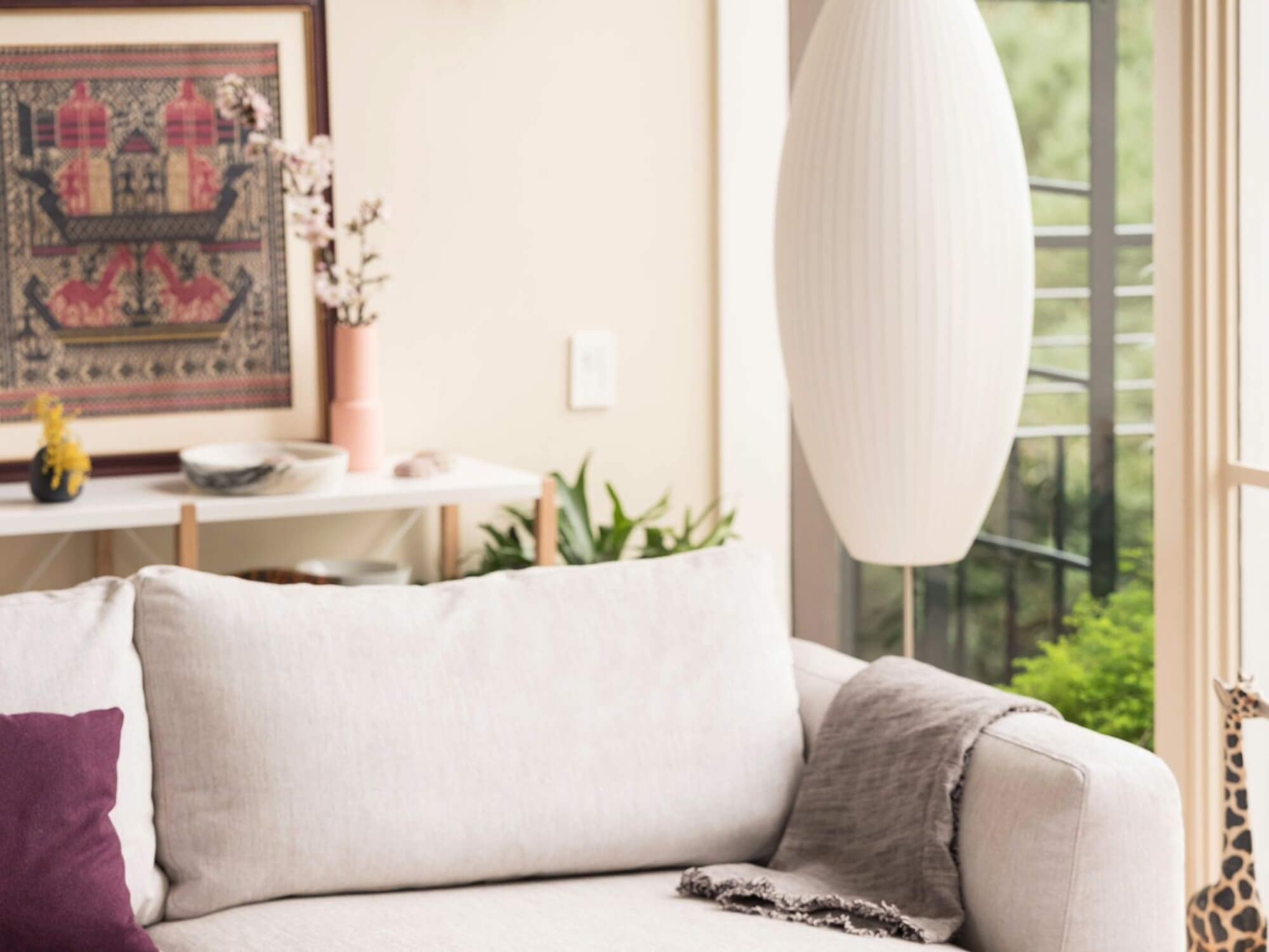 Nelson cigar bubble pendant lamp above beige sectional
