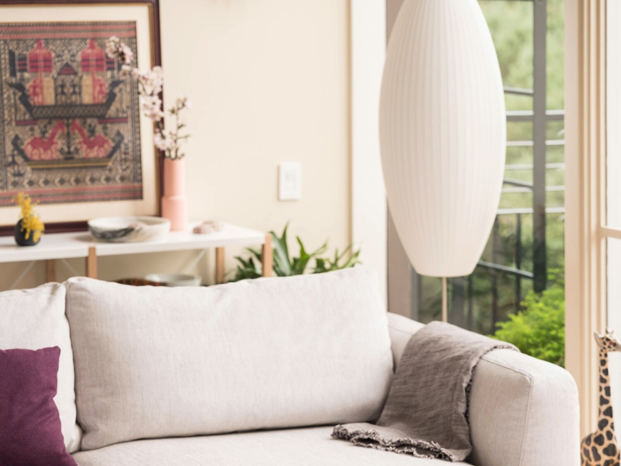 Nelson cigar bubble pendant lamp above beige sectional
