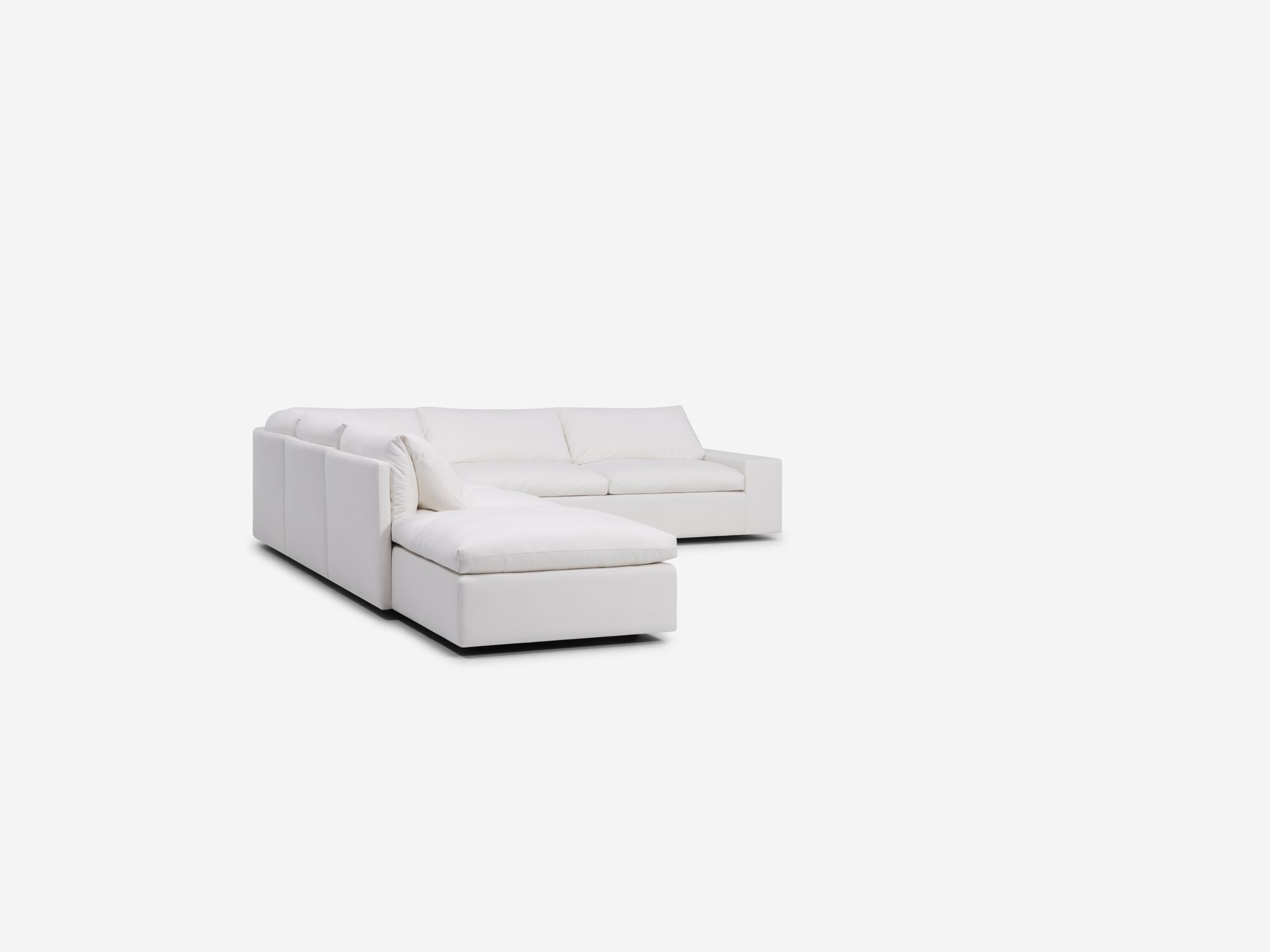 Left angle view of white sectional sofa with left hand chaise and wide arms