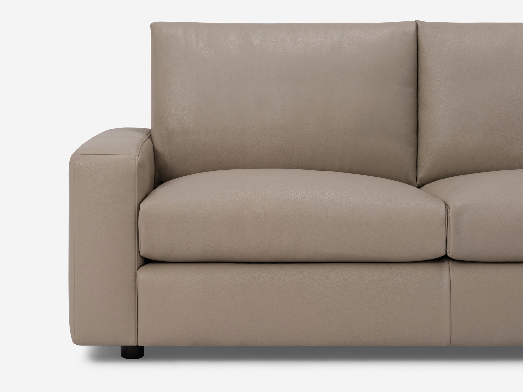 Front detail angle view of grey leather loveseat with narrow arms