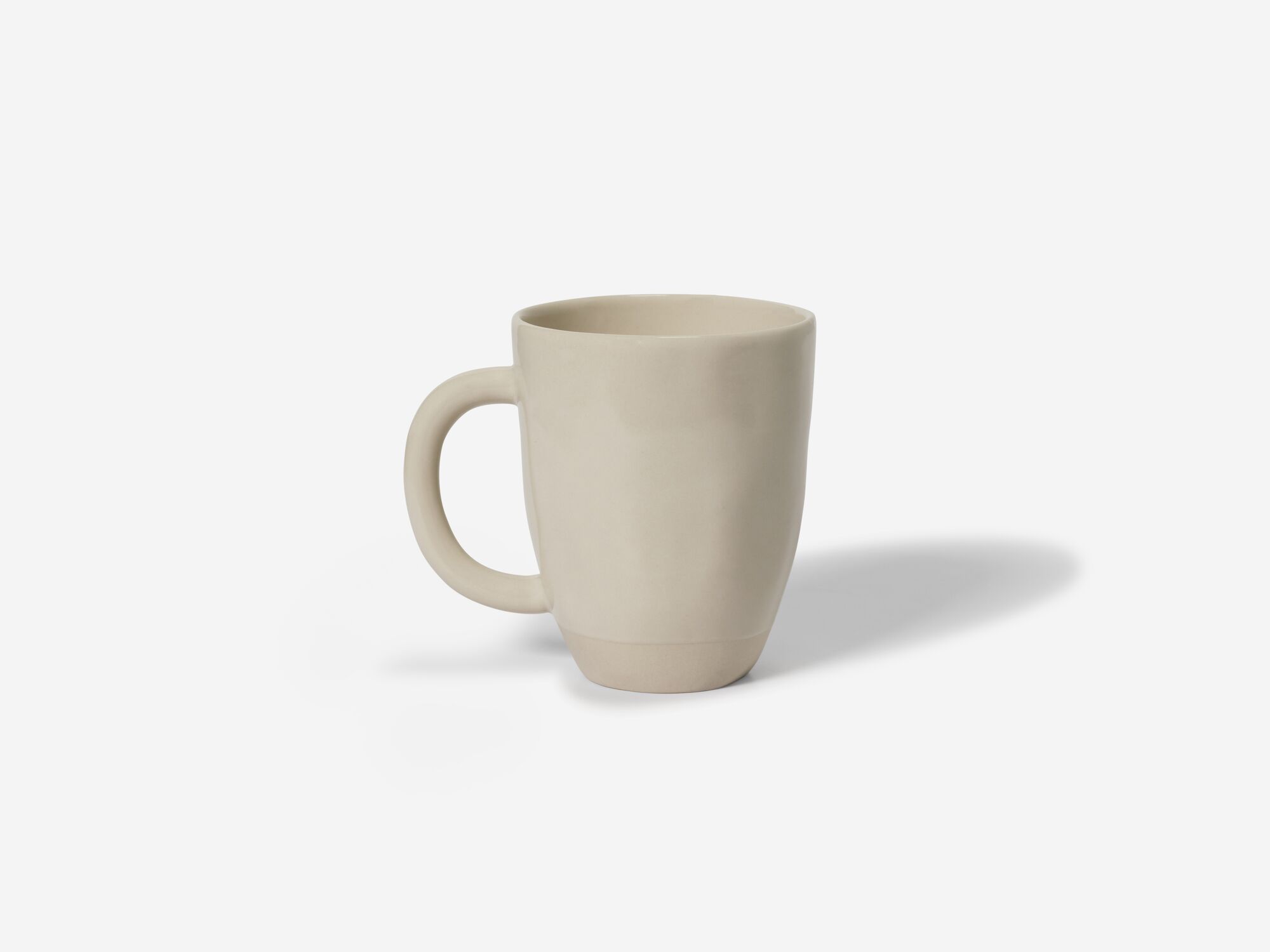 Front view of beige stoneware mug