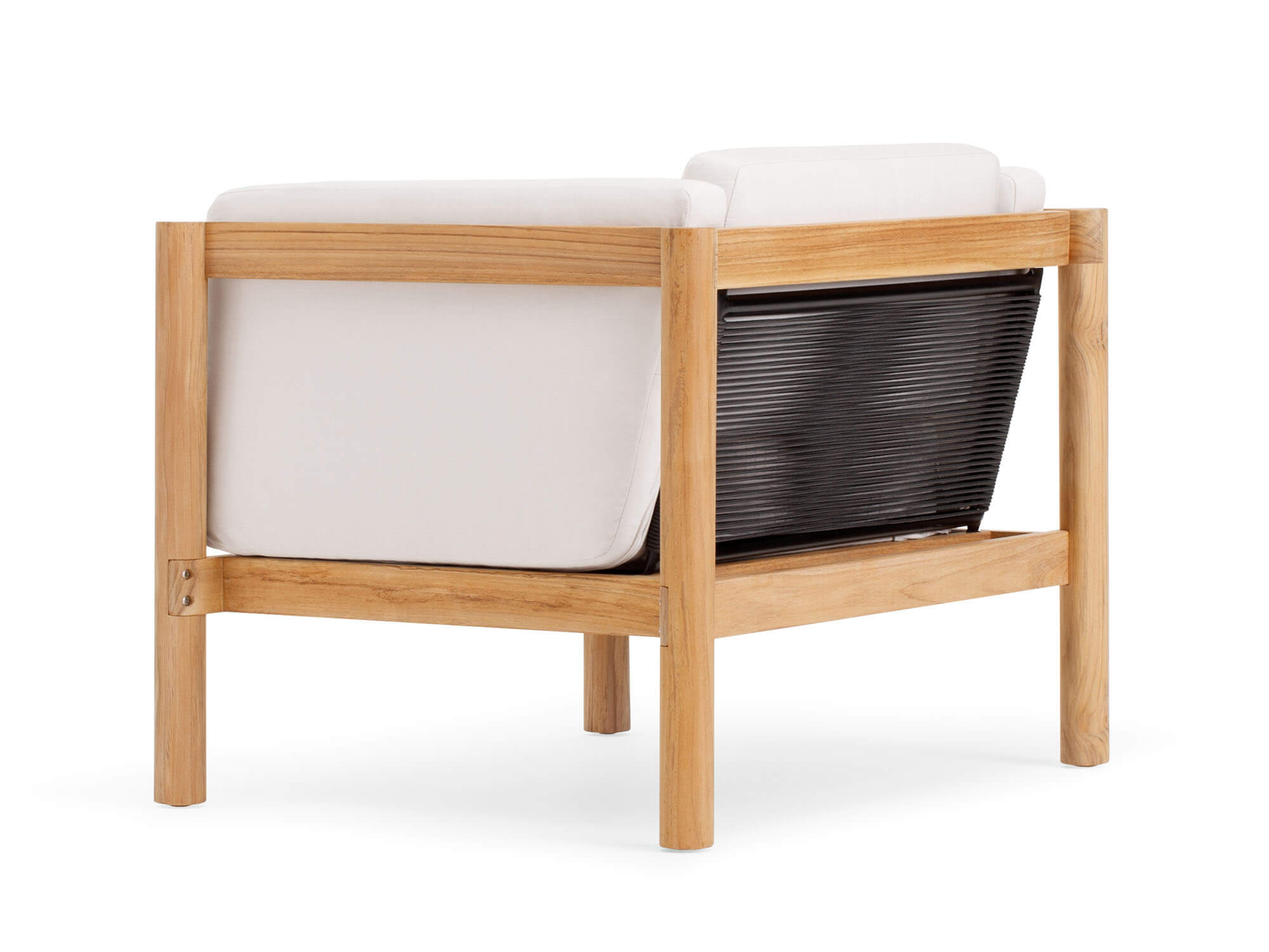 Back angle view of outdoor armchair with white cushions and wood legs