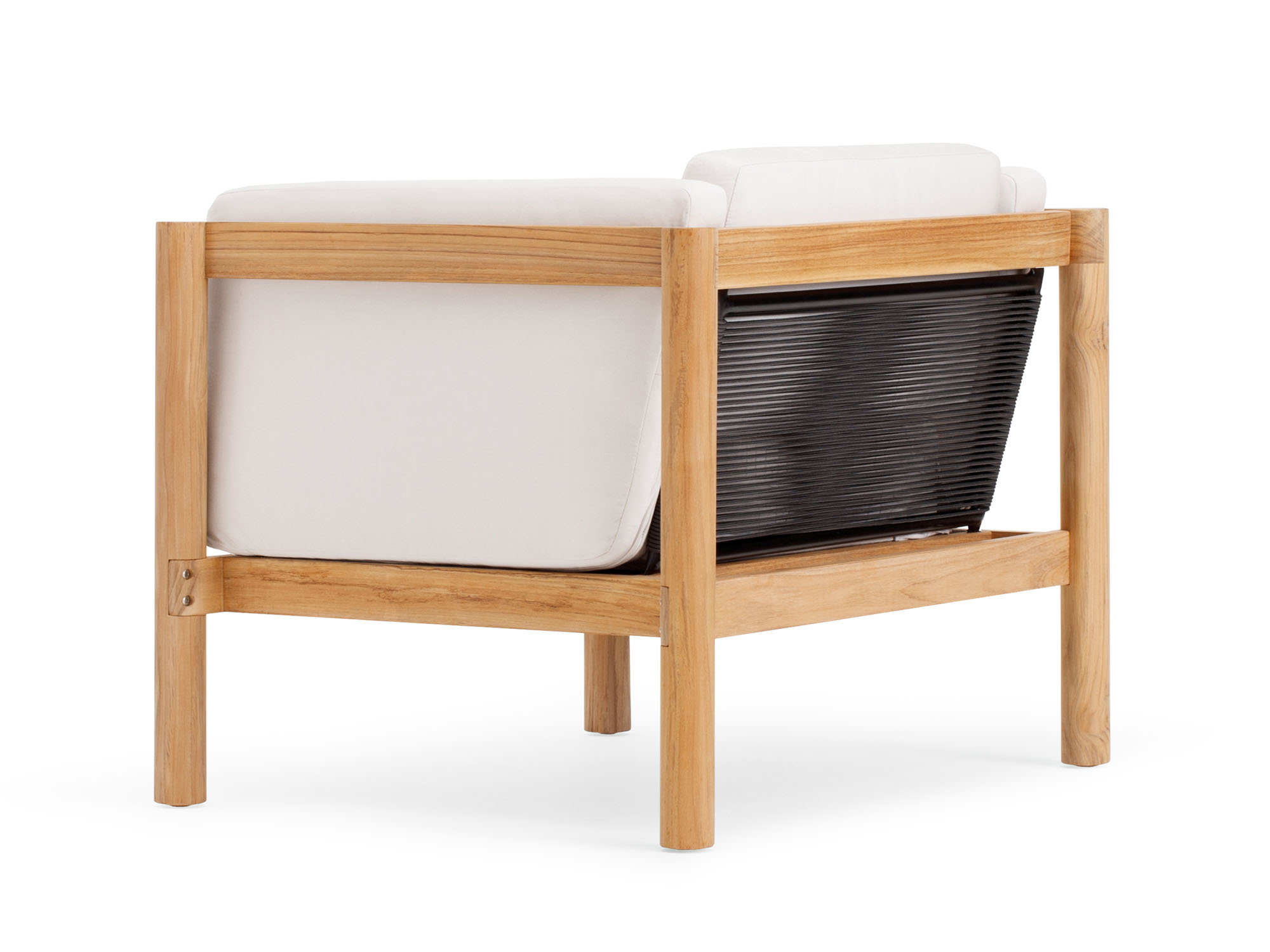 Back angle view of outdoor armchair with white cushions and wood legs