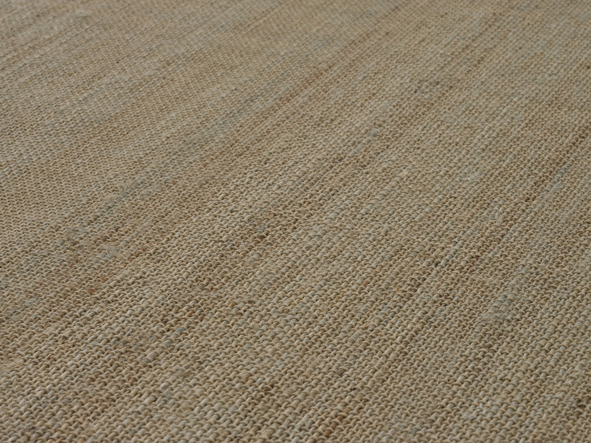 Detail view of green hand woven jute large rug