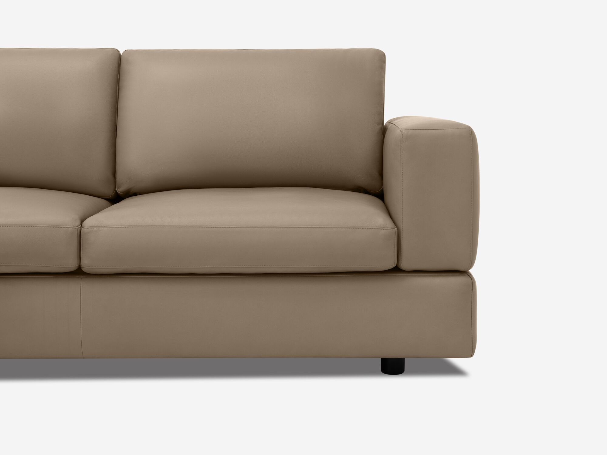 Front detail view of taupe leather sectional sofa