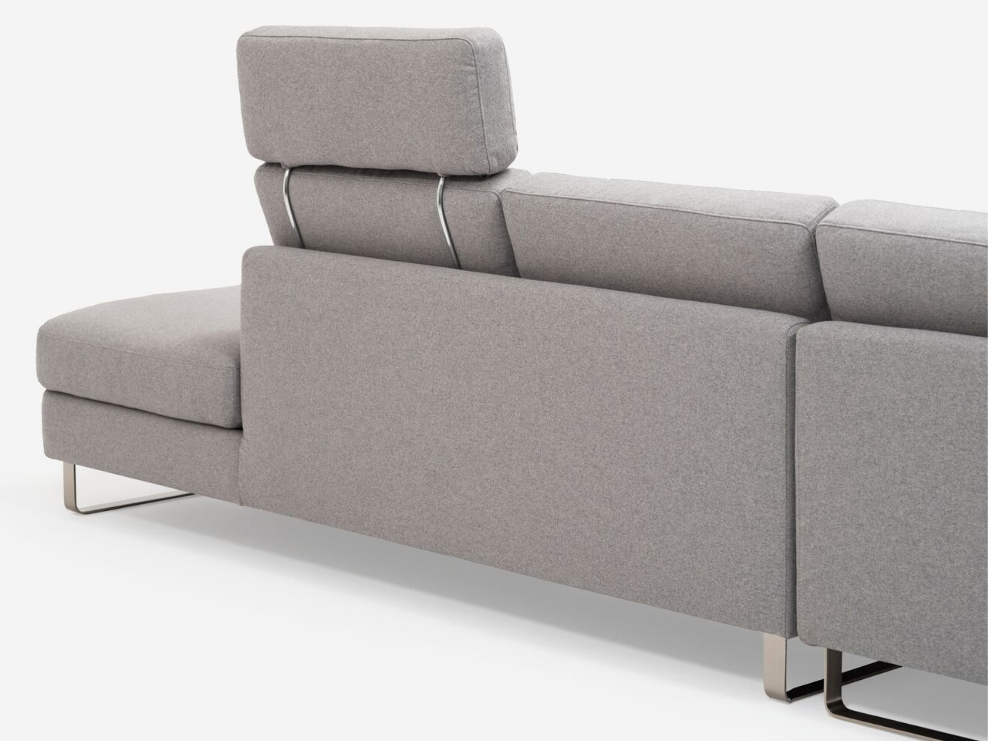 Back right detail view of grey 2-piece sectional sofa with headrest