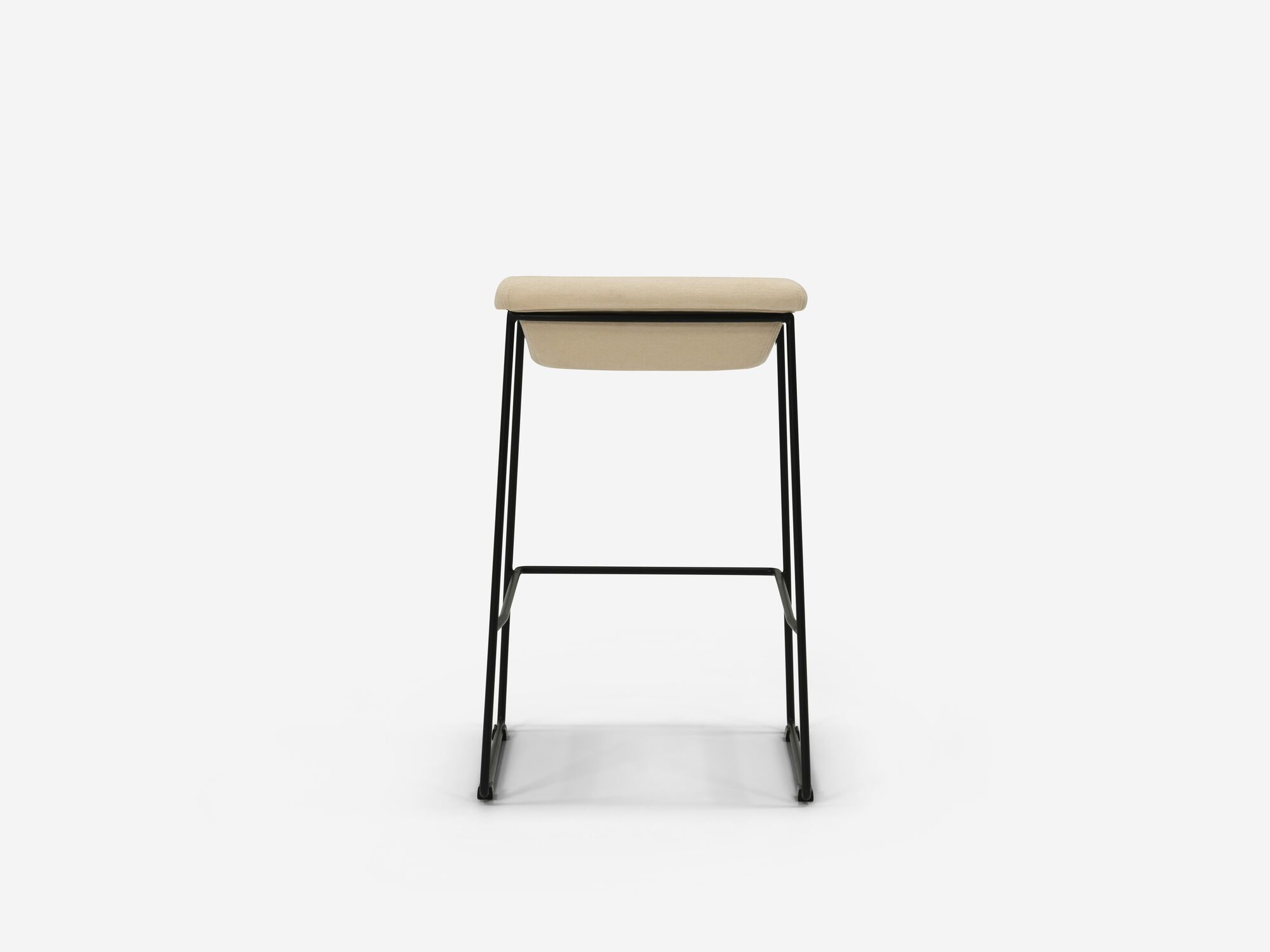 Back view of counter stool with beige seat and black legs