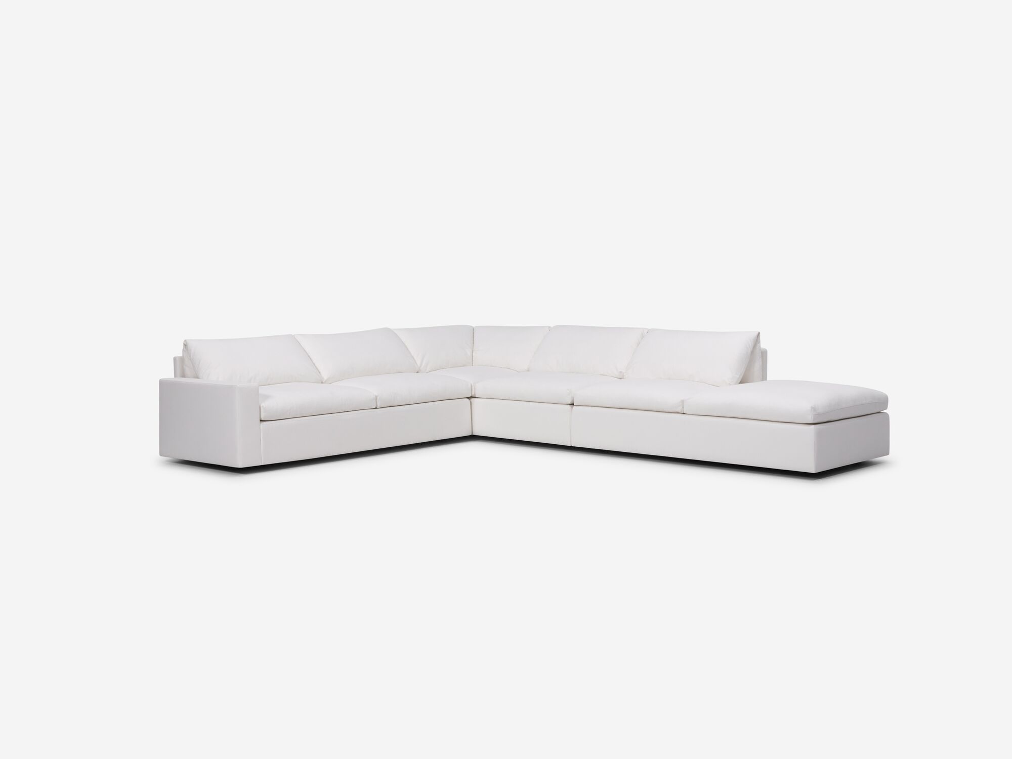 Right angle view of white sectional sofa with right hand chaise