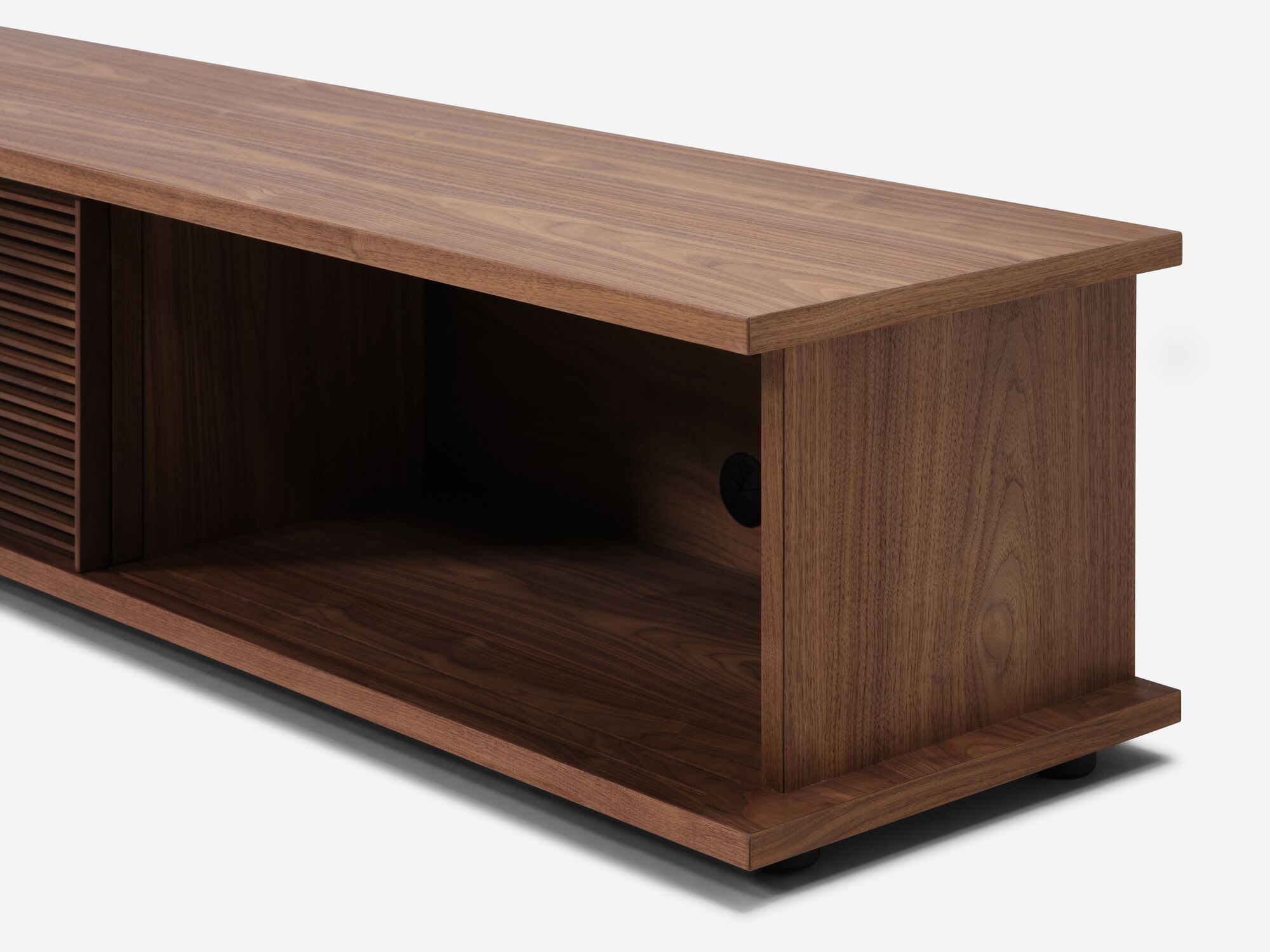 Detail view of the Plank mid century media console in walnut with slatted door open